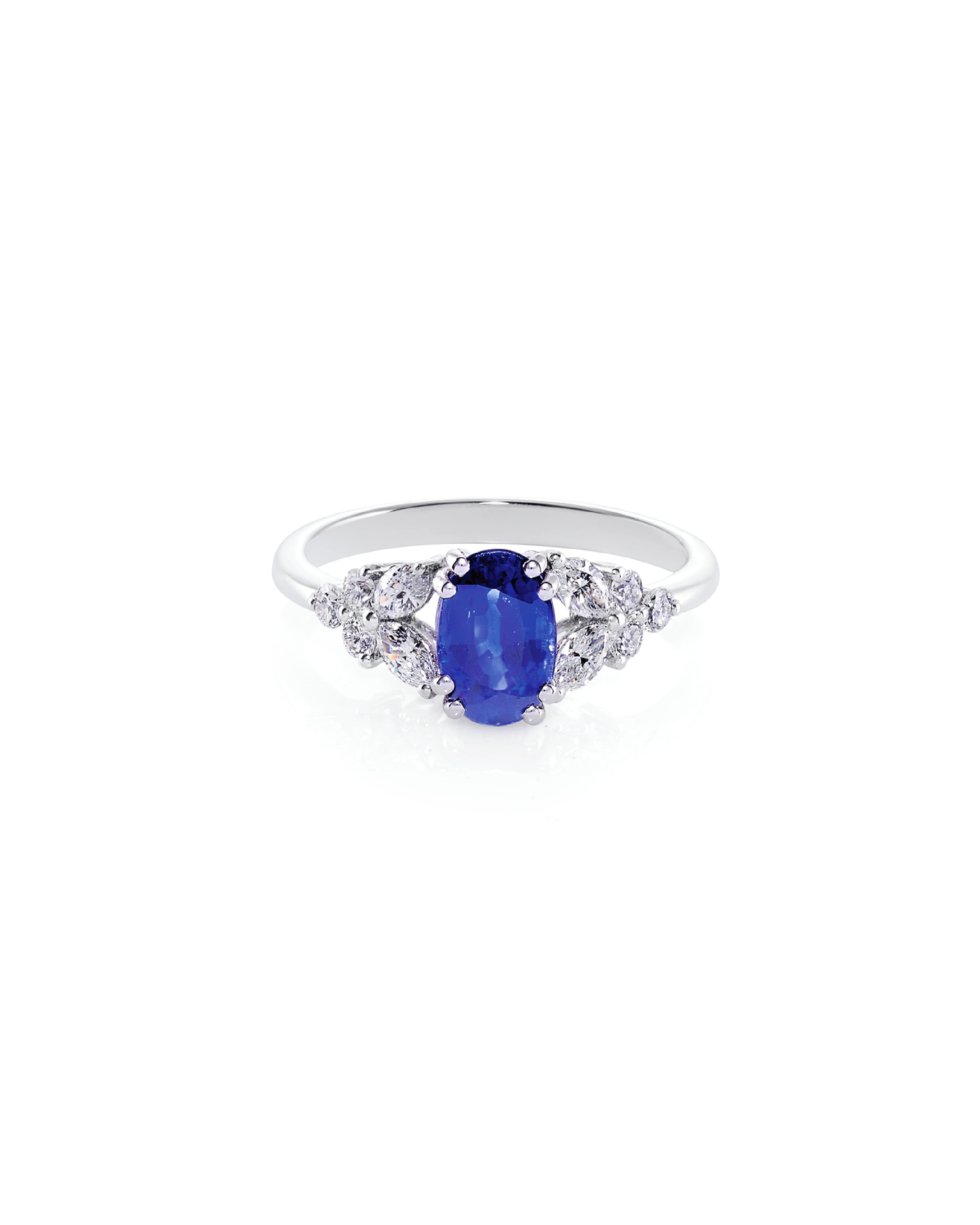 An elegant oval blue sapphire and diamond ring with marquise and round brilliant cut diamonds set in solid white gold.