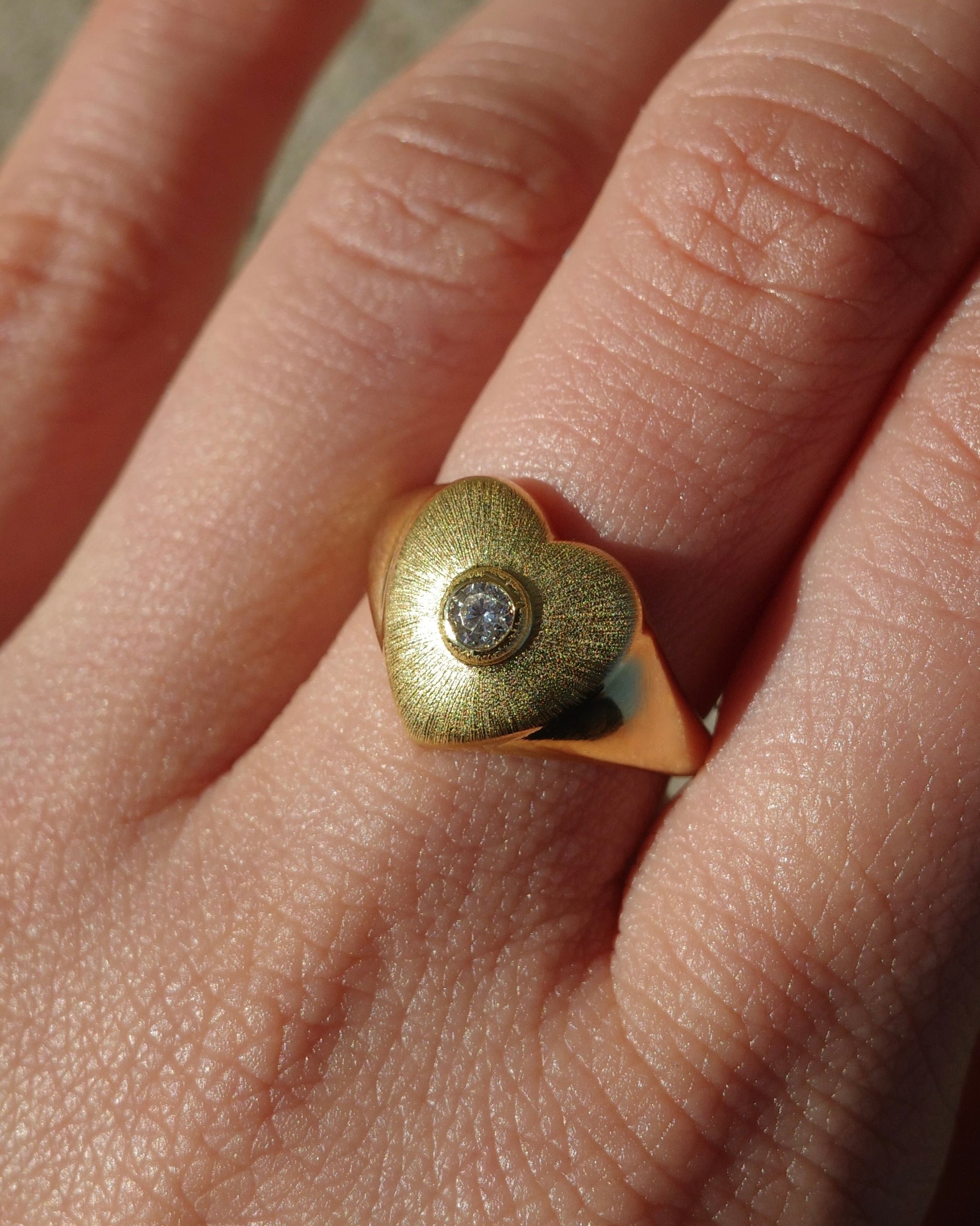 Heart Gold signet with bezel set round brilliant cut diamond