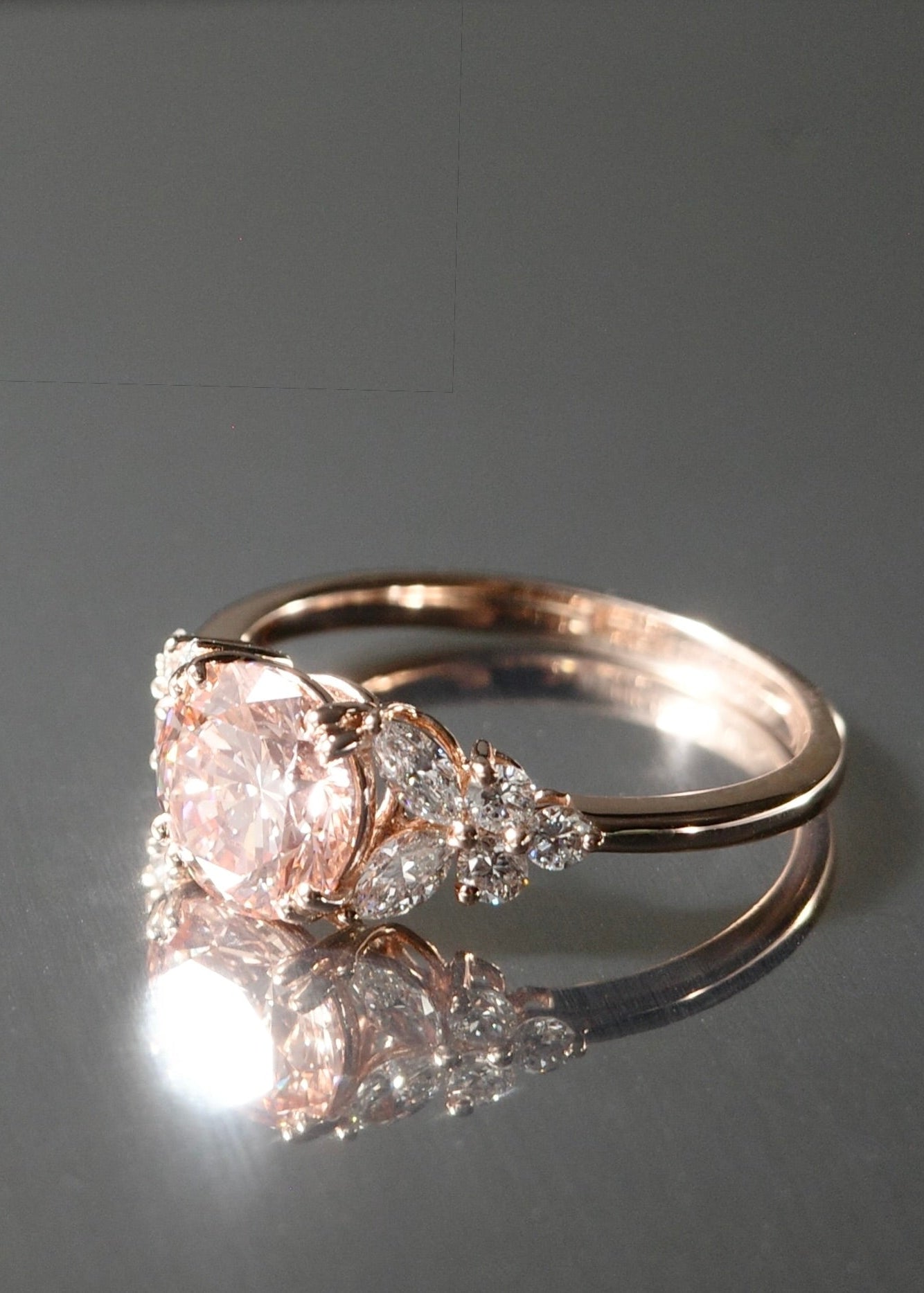 Rose gold ring with pink diamond and marquise diamond side accents