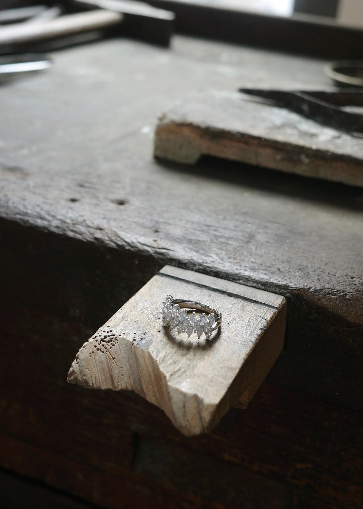 The Fleur marquise diamond ring on jeweler work table.