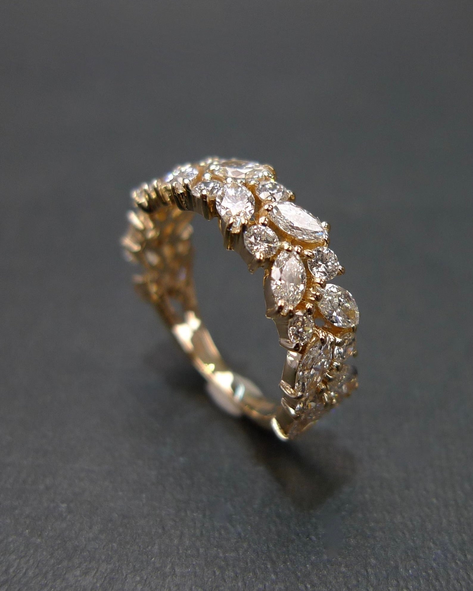 Handcrafted half eternity ring with marquise cut and round brilliant cut diamonds in solid yellow gold