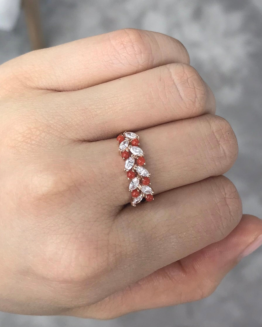 Ring with orange red coral and marquise diamond on a hand