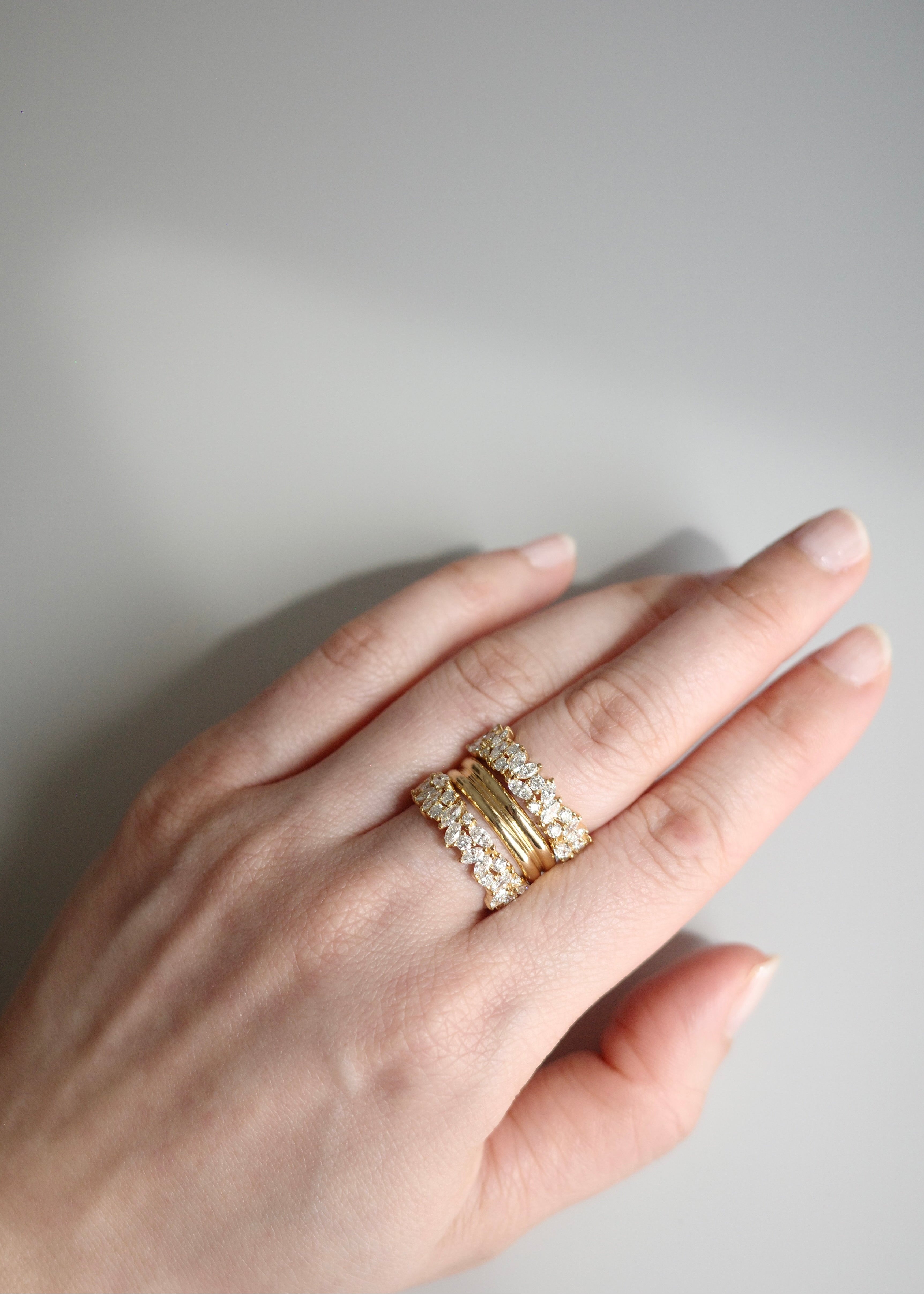 Elegant yellow gold eternity band with marquise and round diamonds
