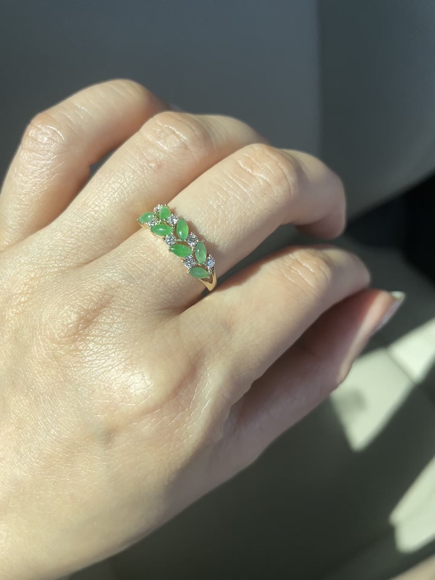 a wedding ring set with 7 natural marquise green jades and 7 round brilliant cut diamonds