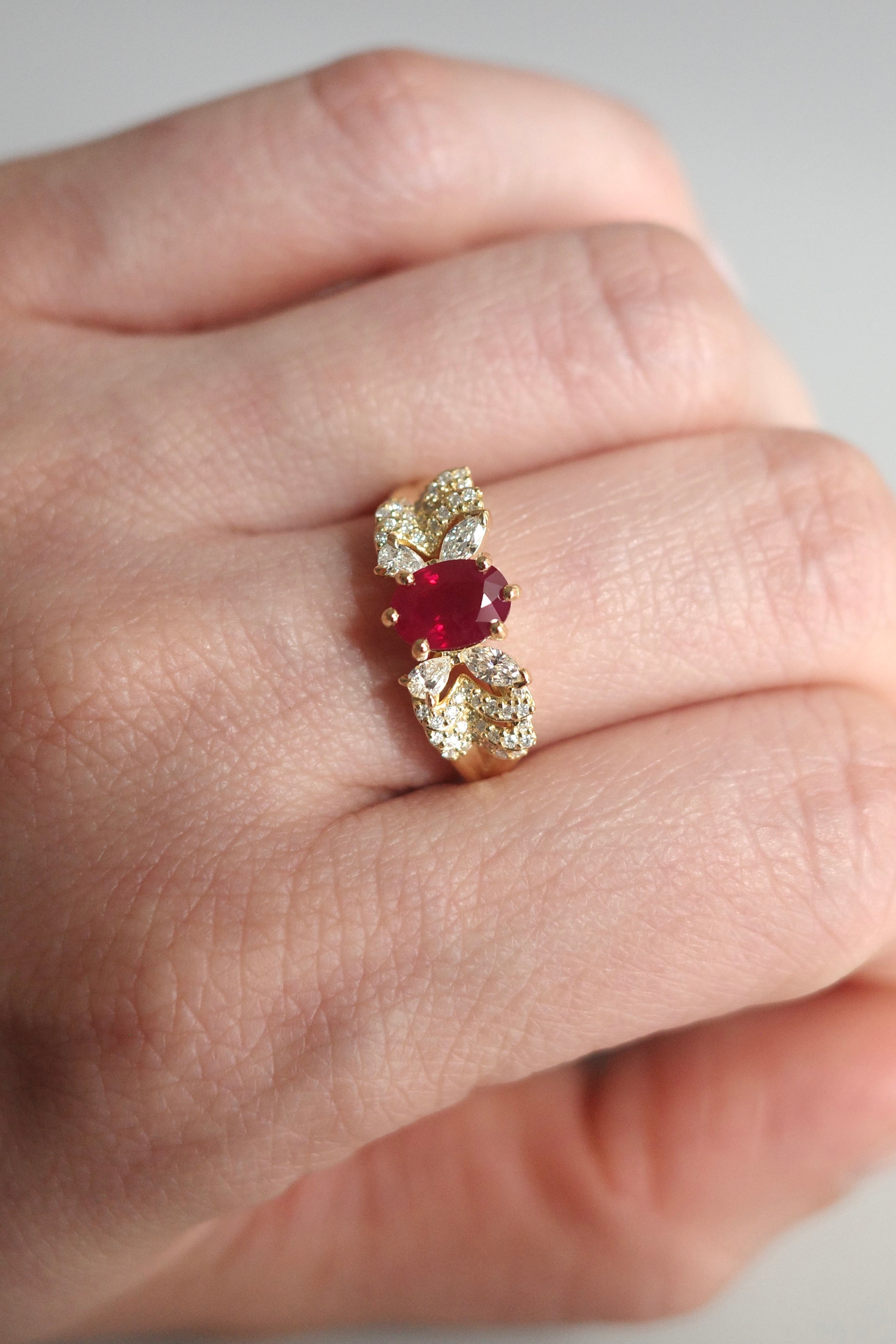 Oval ruby ring set in 14k solid gold with marquise diamonds, pear diamonds and round diamonds