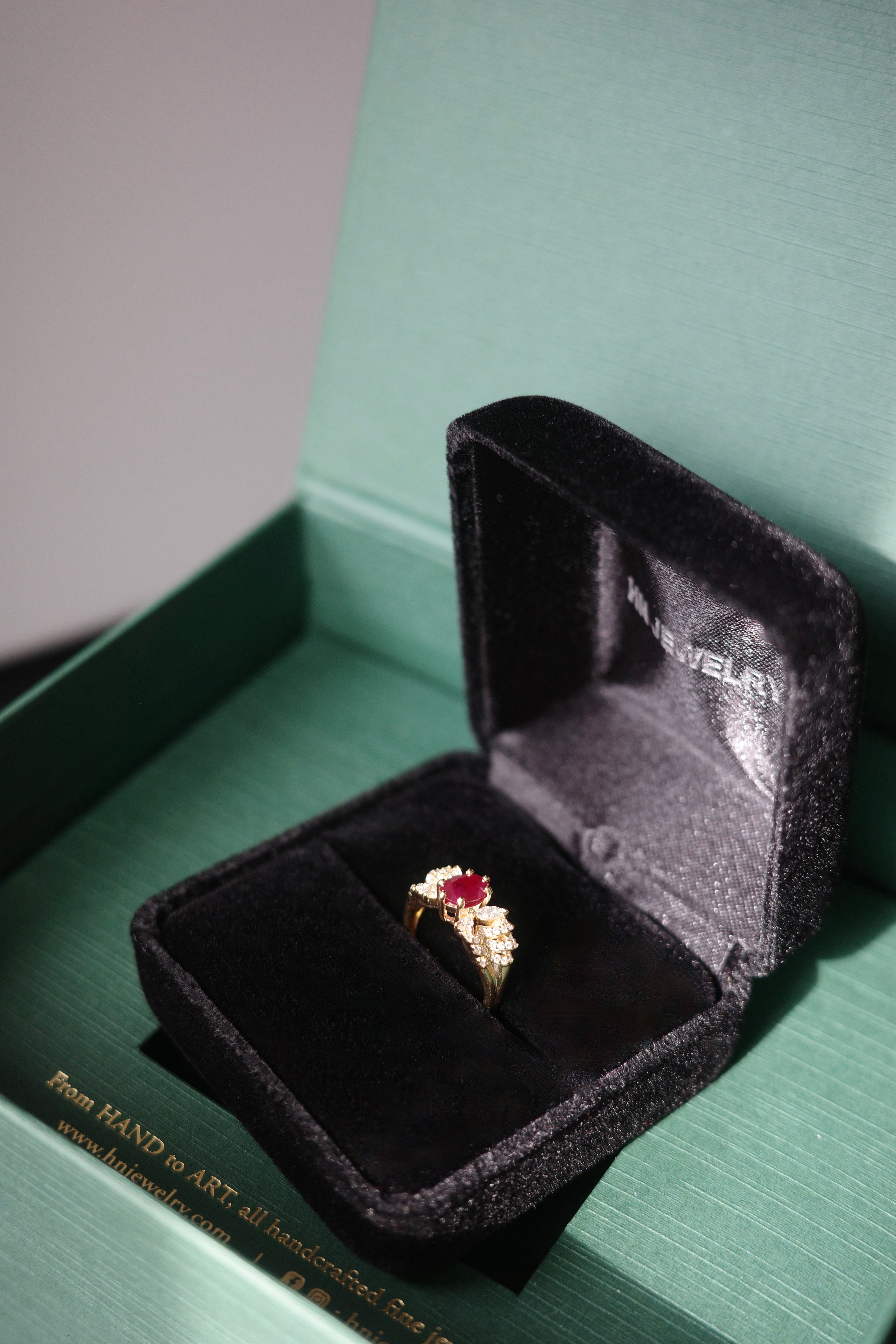 Elegant ruby ring with butterfly style diamond details in solid 14k gold