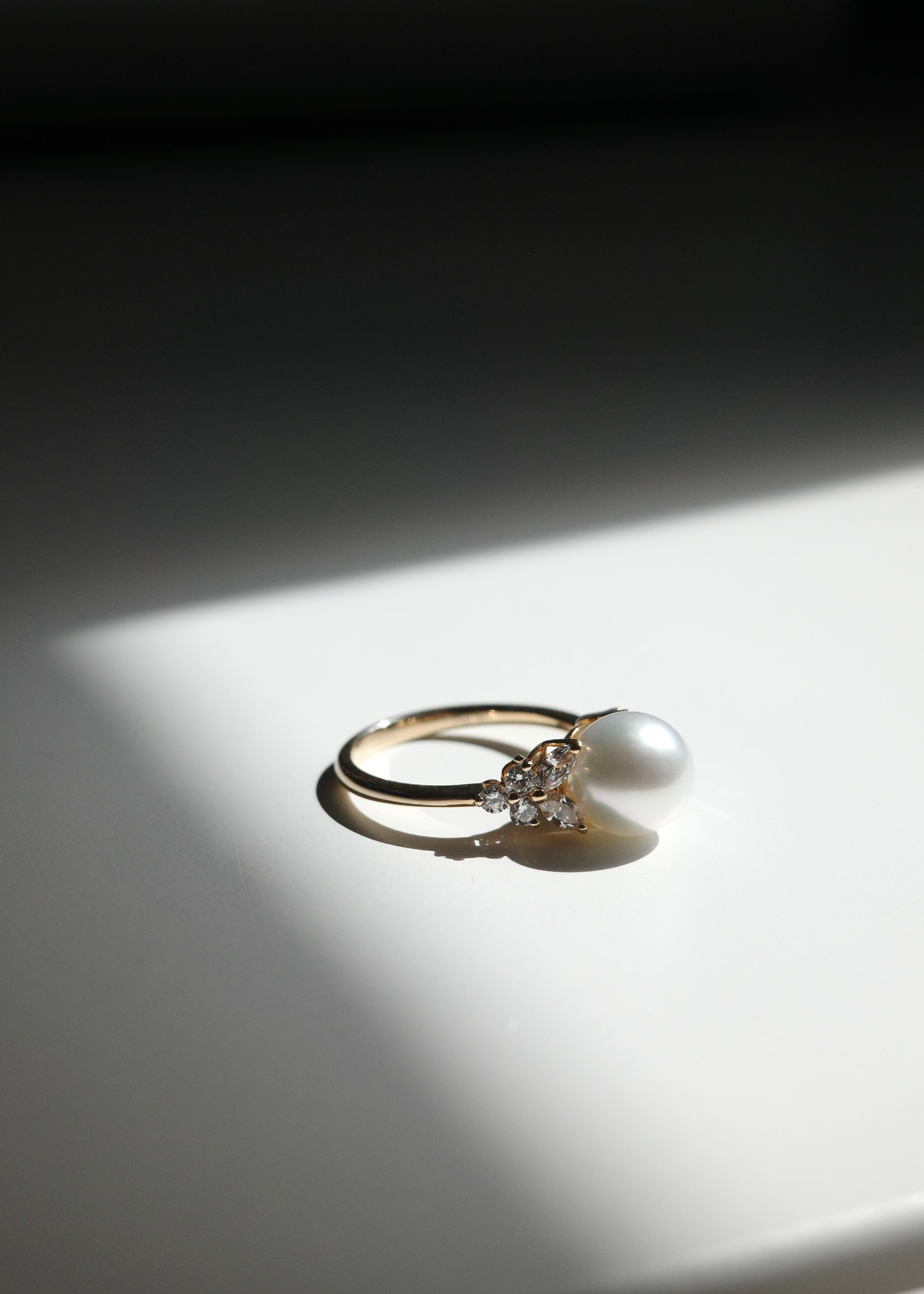 An unique ring set with natural south sea white pearl at the center with marquise diamonds and round diamonds on the side
