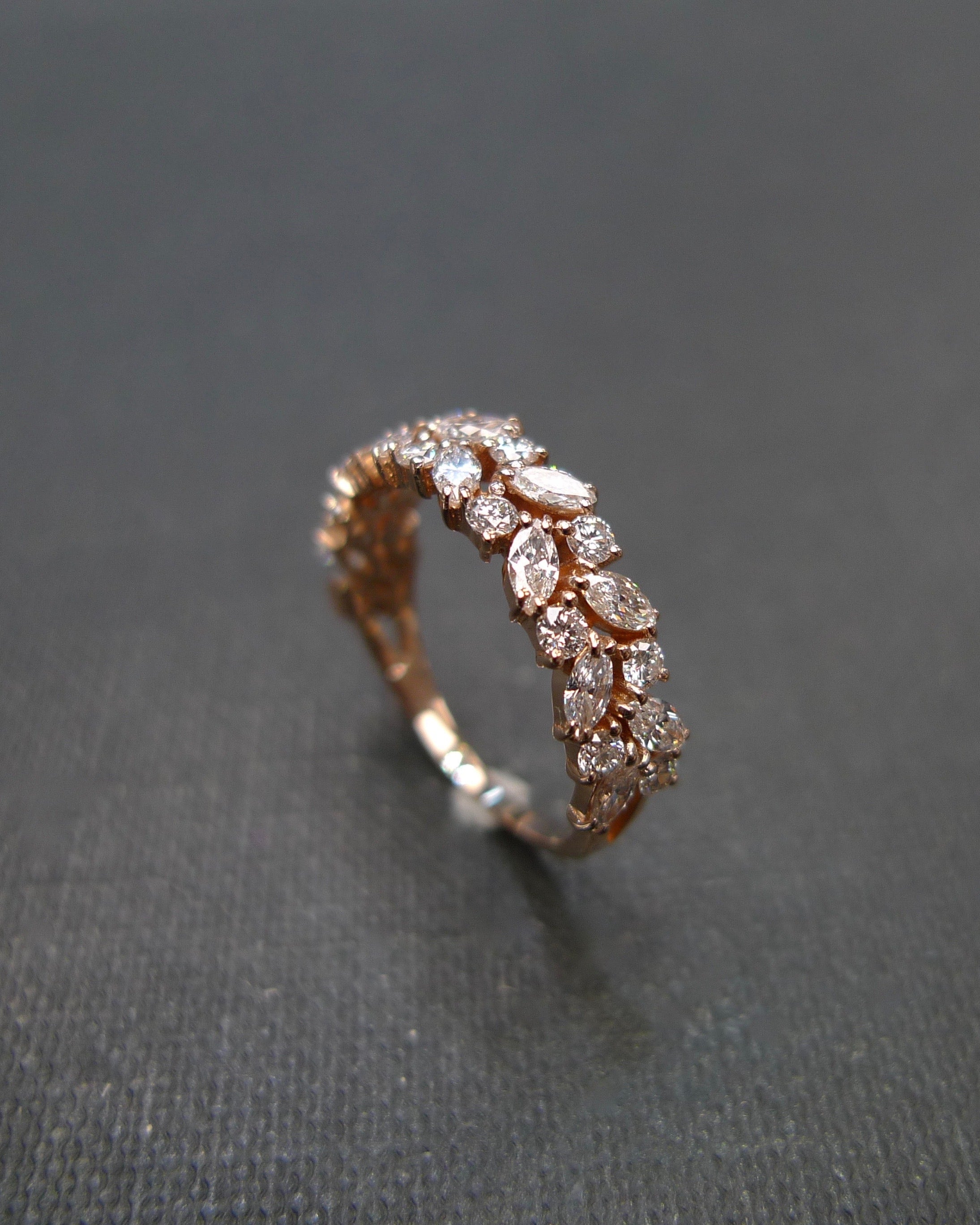elegant rose gold half eternity band with marquise cut diamonds