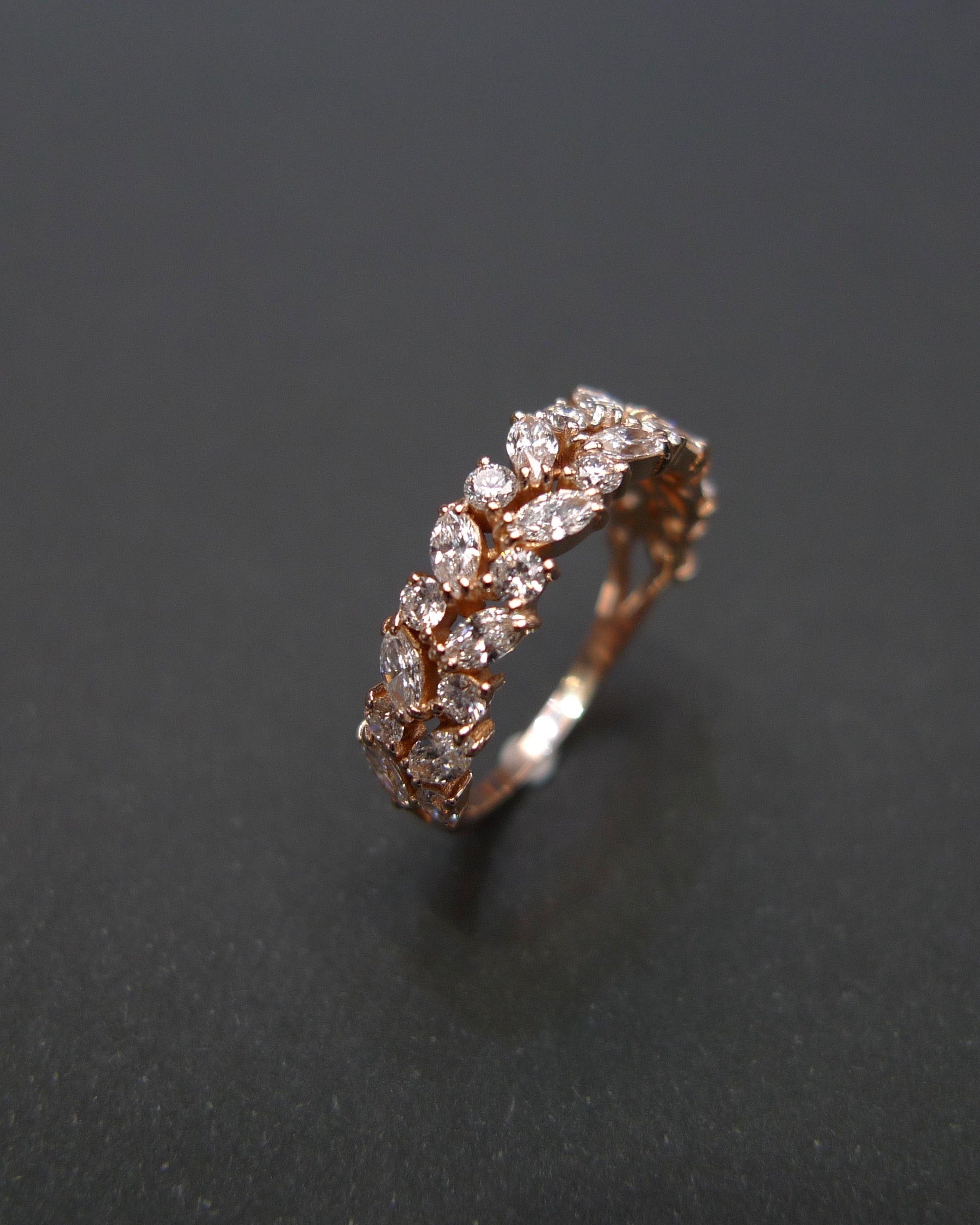close up marquise diamond ring in rose gold half eternity design