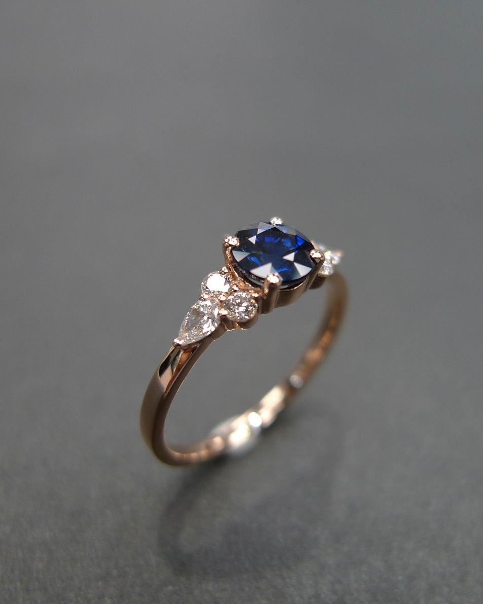Natural blue sapphire ring with pear diamonds and round brilliant cut diamonds
