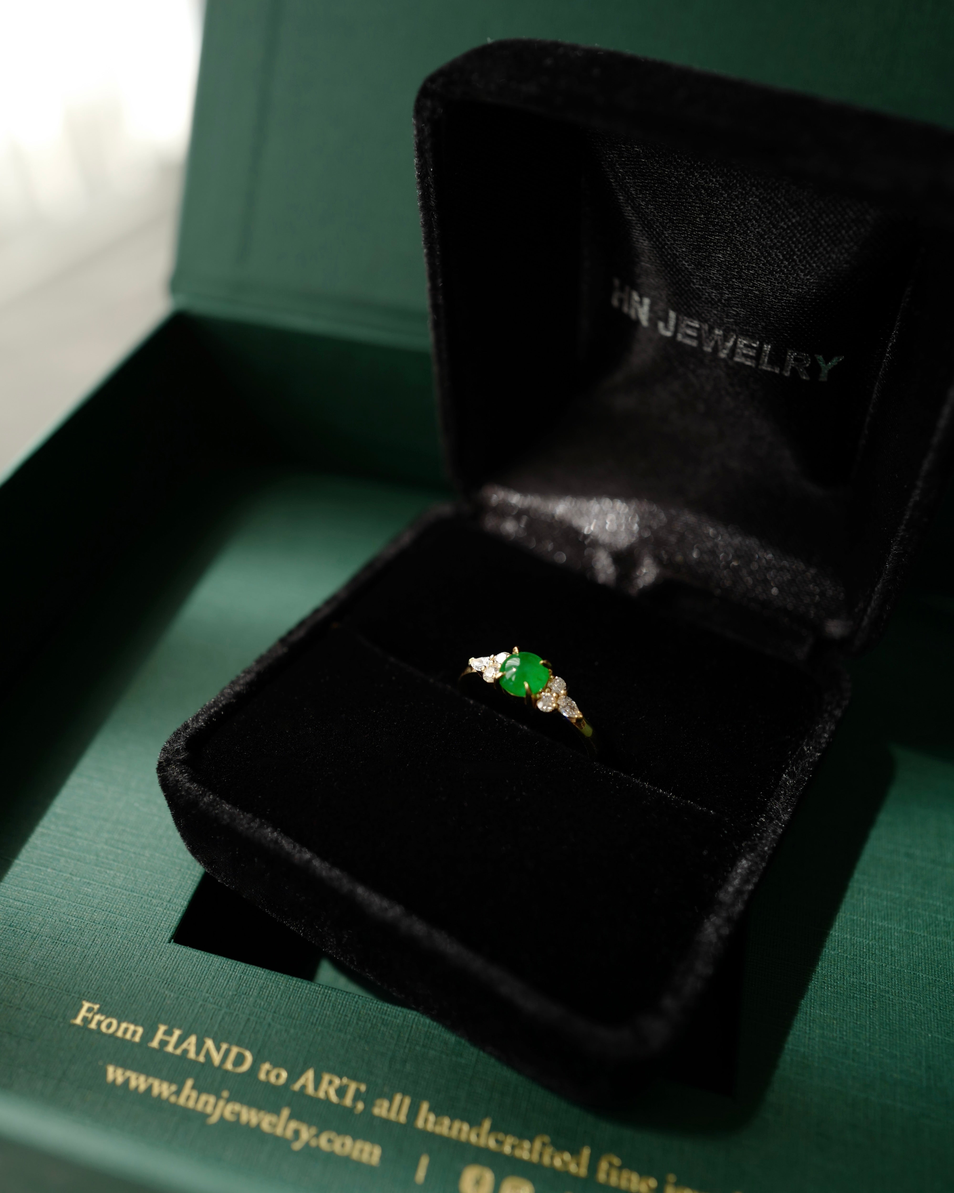 Jewelry box with a ring featuring 5mm round natural green jade and pear diamonds