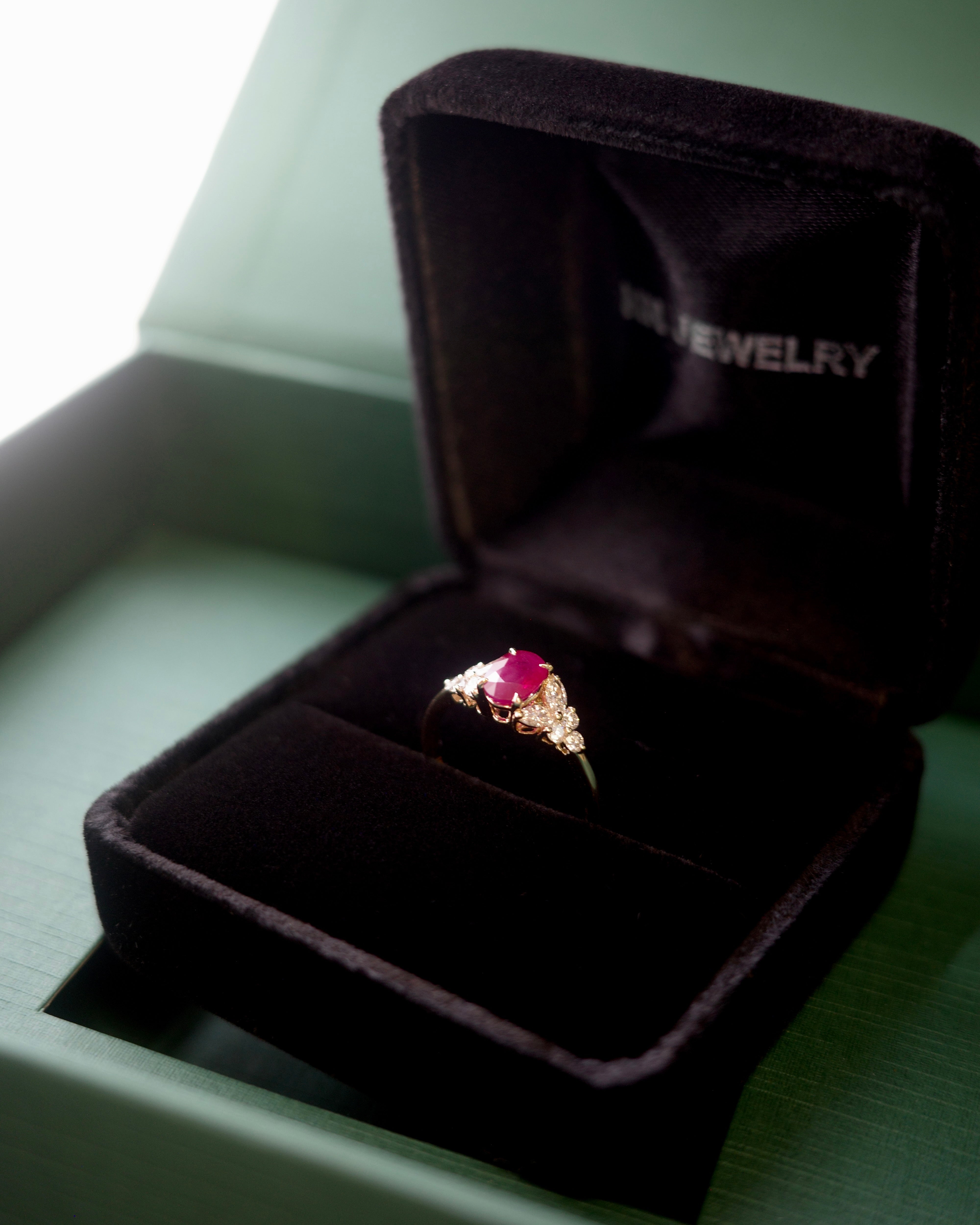 Ring with a pigeon blood ruby in an open hN Jewelry brand jewelry box