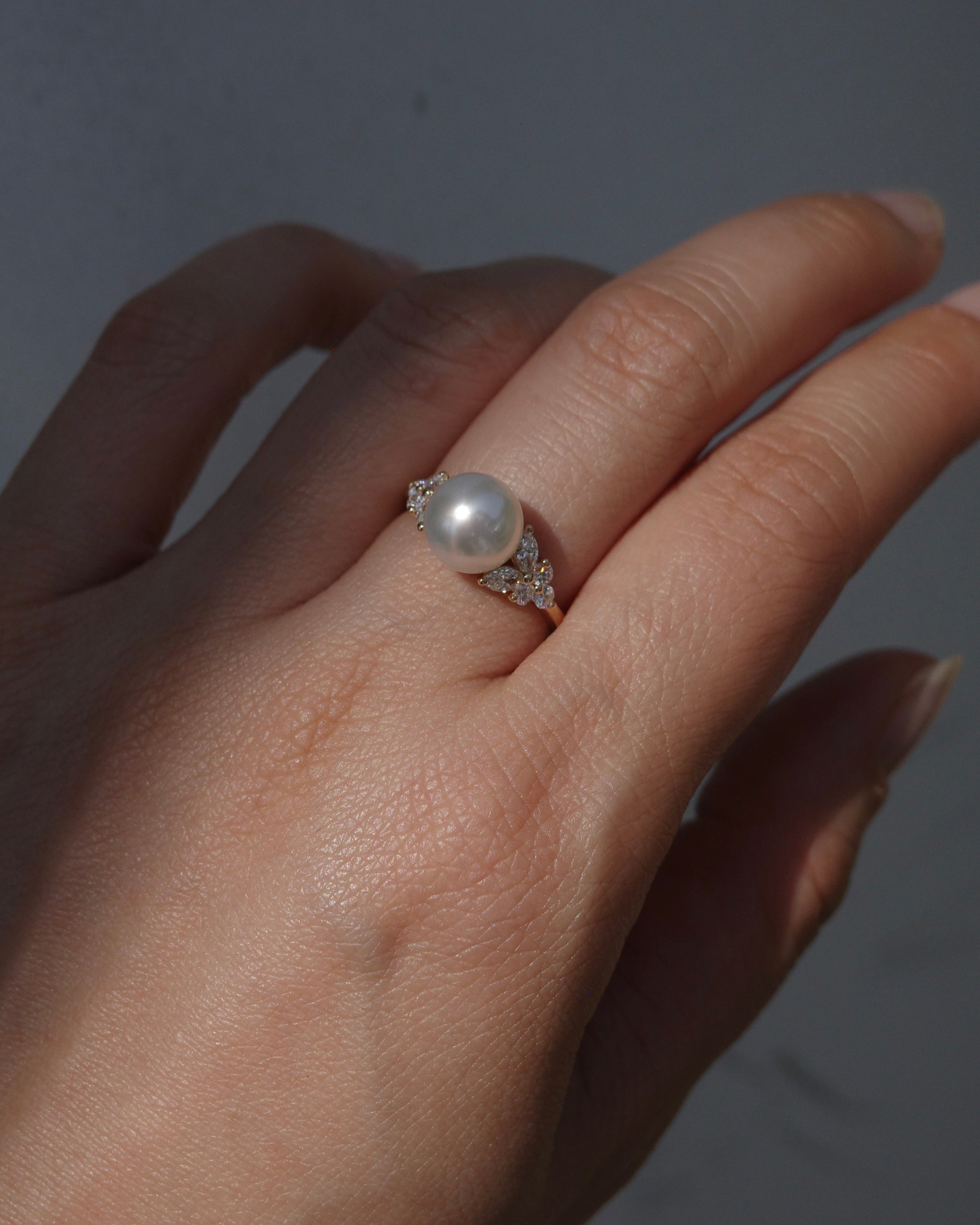 A beautiful ring set with a south sea pearl at the center along with marquise diamonds and round brilliant cut diamonds on the side. It is made in 14k solid yellow gold. 