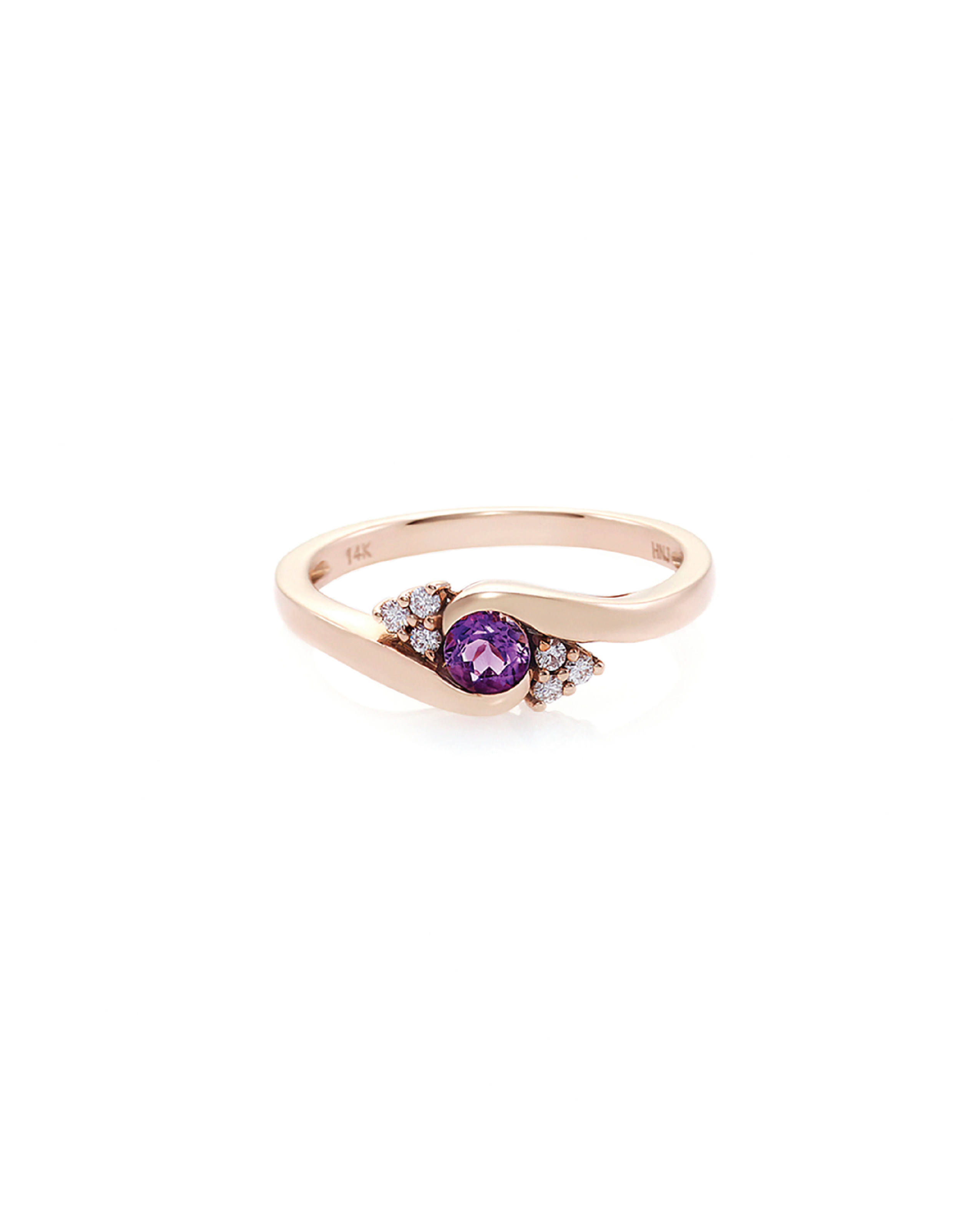 A rose gold ring with a central amethyst gemstone and round brilliant cut diamonds on either side.
