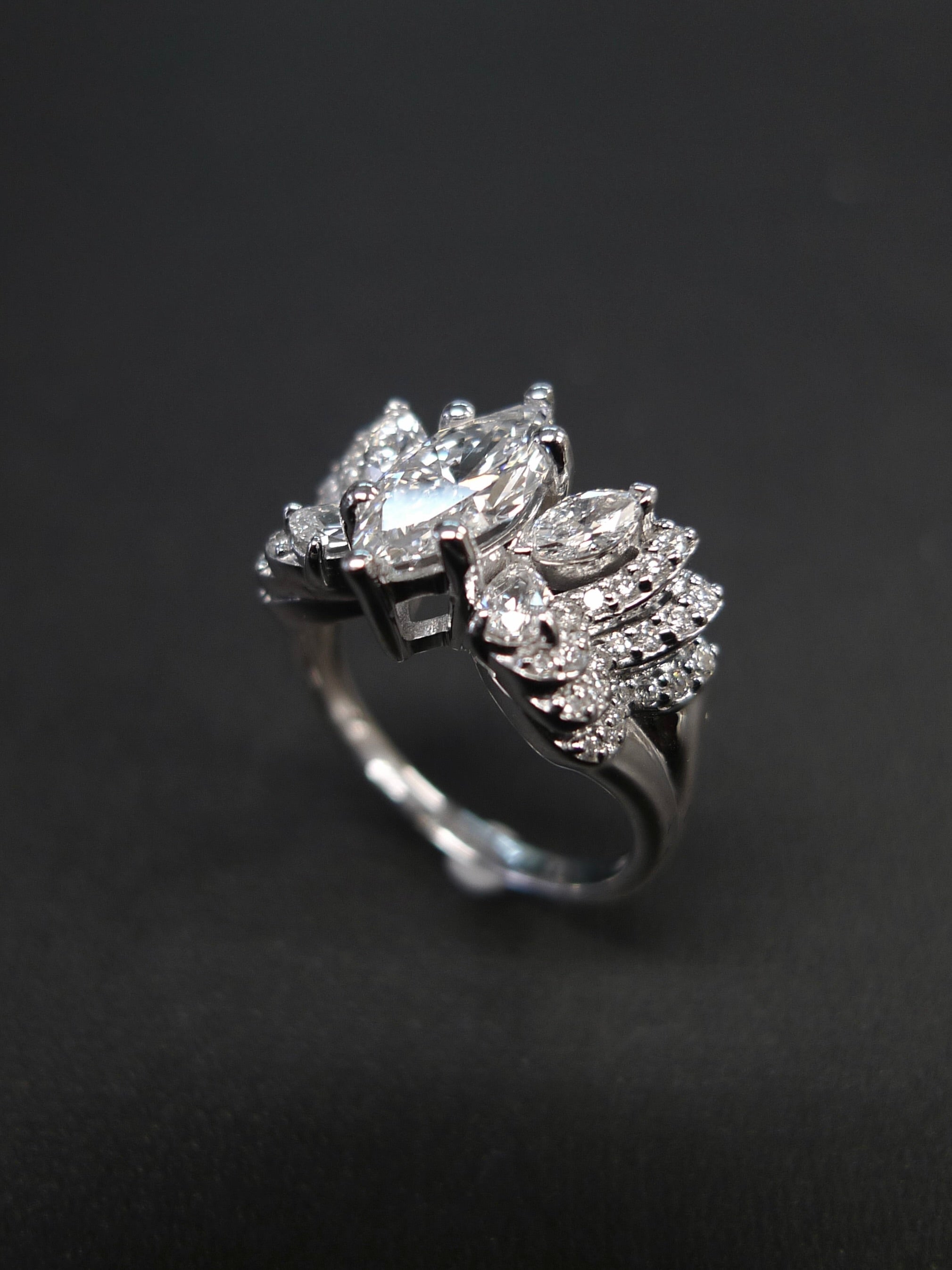 14k white gold ring with 1ct marquise at the center along with marquise diamond and pear diamond on the side