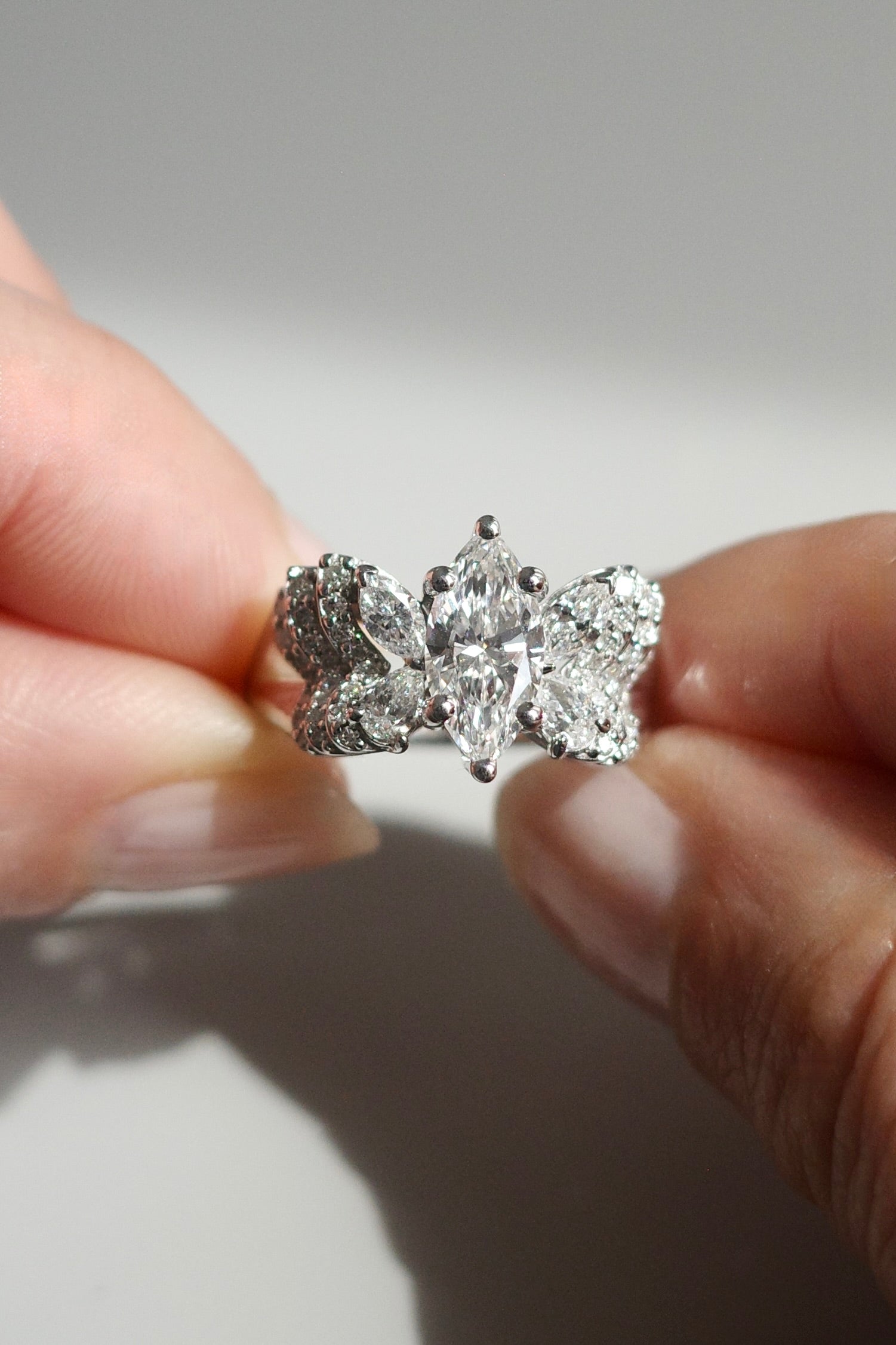 White gold butterfly diamond ring with marquise, pear, and round brilliant diamonds