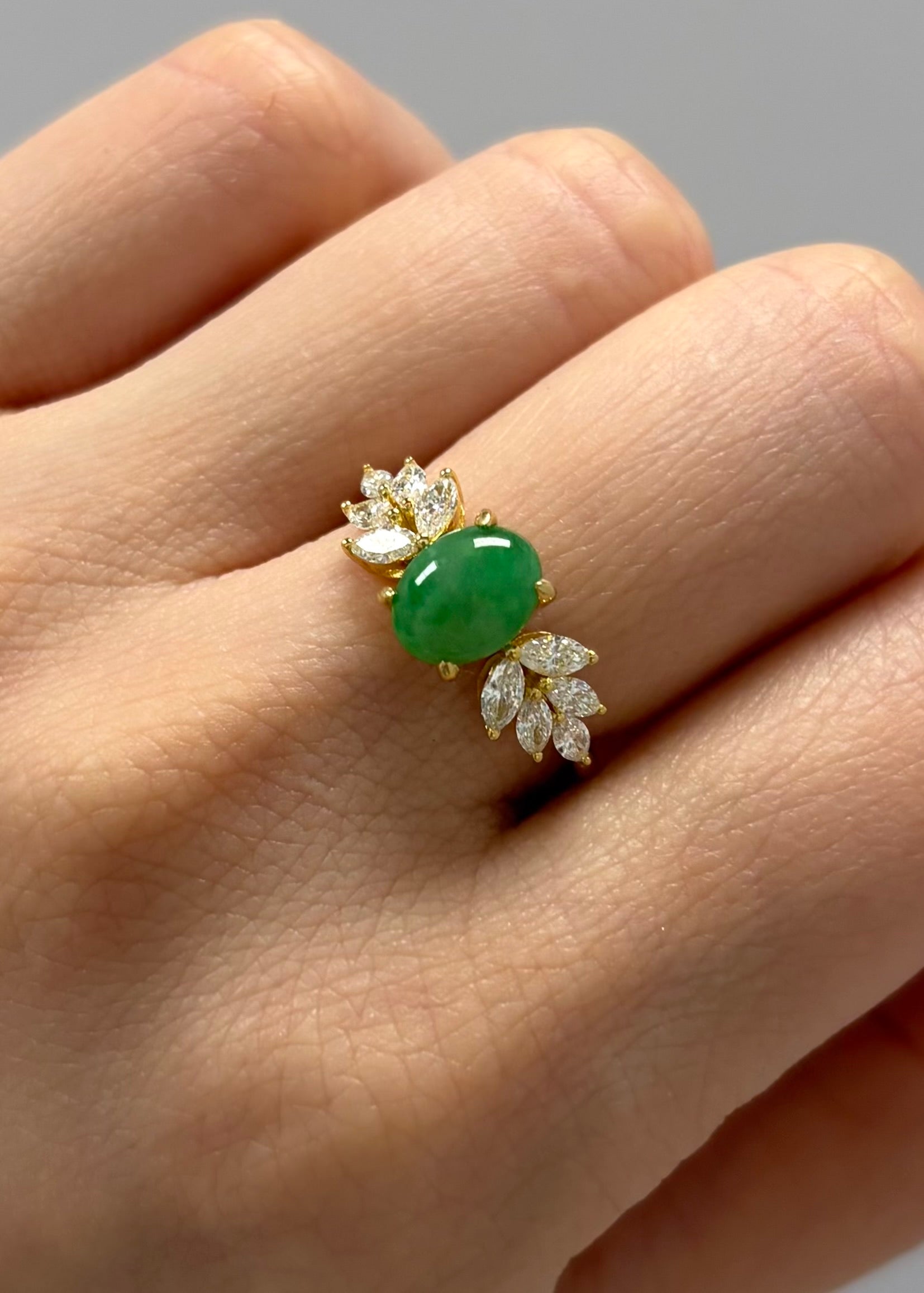 Natural oval jade ring with marquise diamond accents in yellow gold