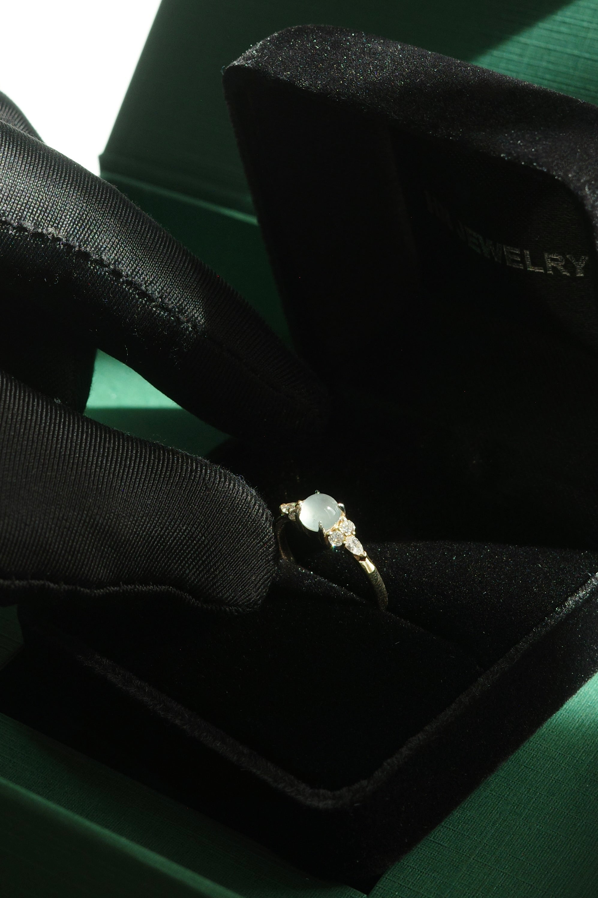 Elegant icy jade ring with round brilliant and pear diamonds