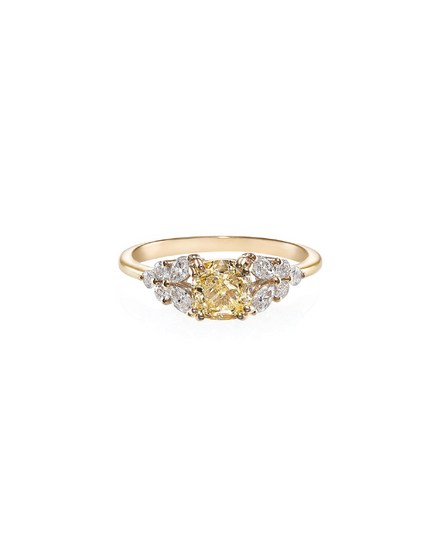 A cushion-shaped yellow diamond ring with round and marquise cut diamonds set in a 14K yellow gold band.