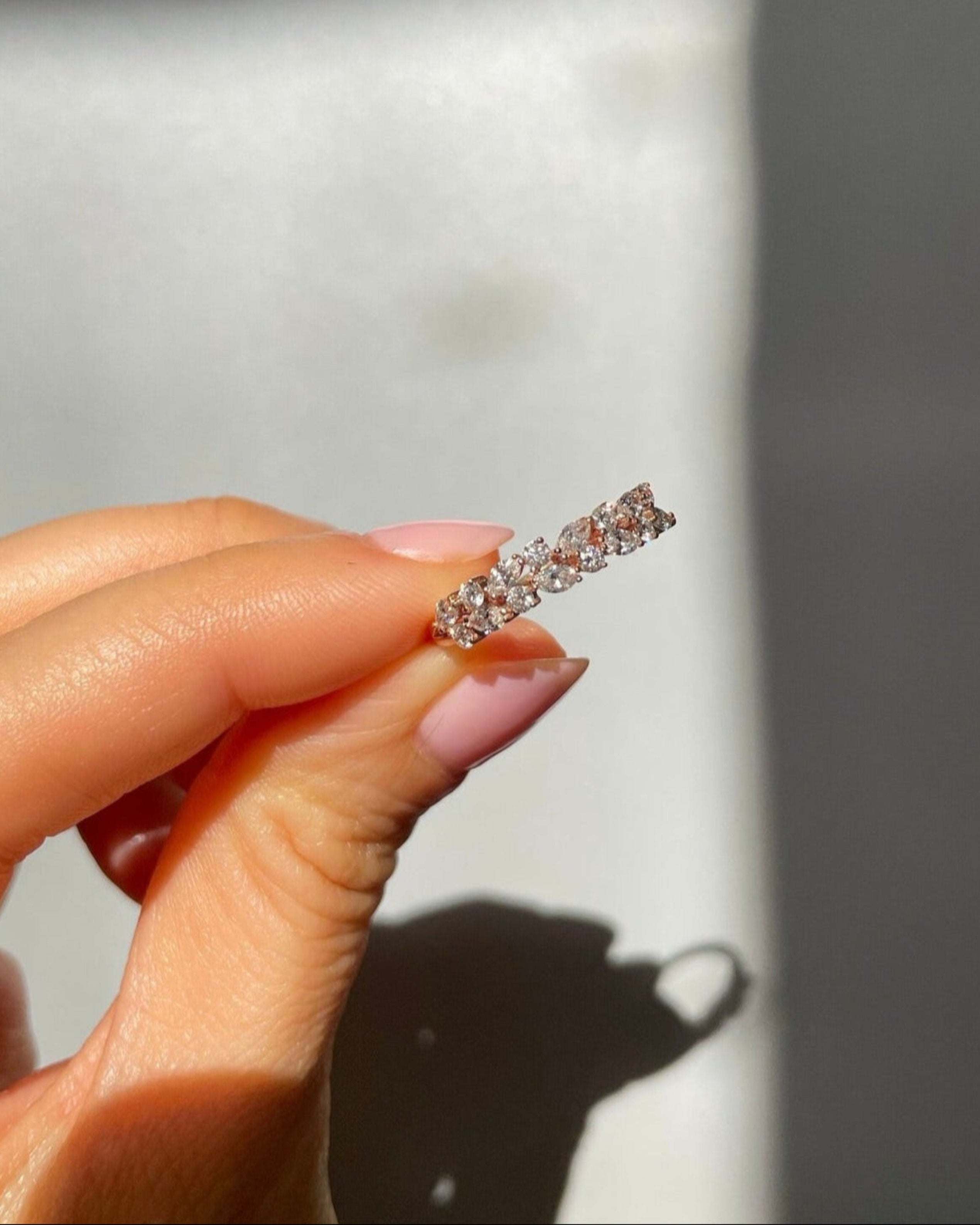 Hand holding a marquise diamond ring
