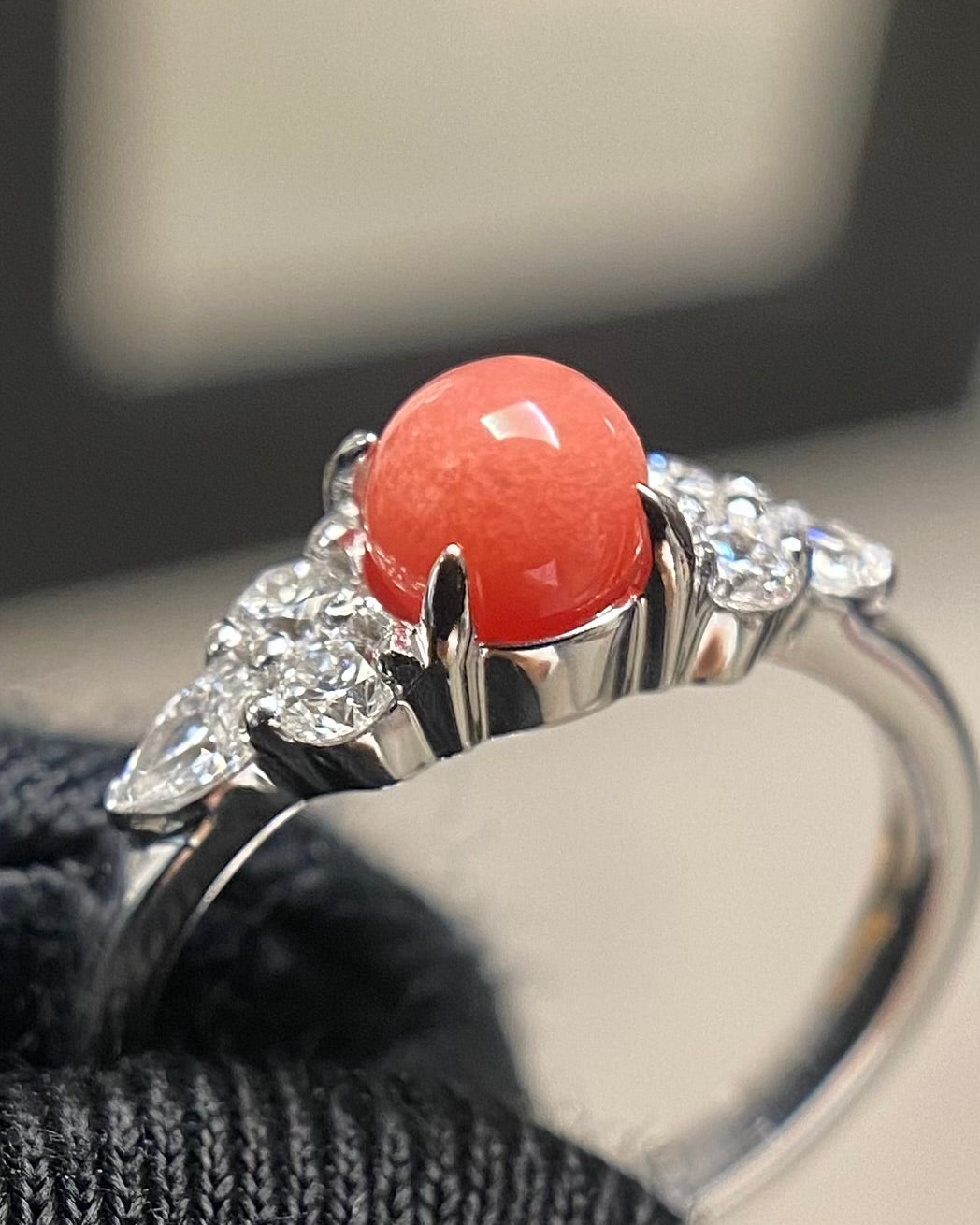 a close up showing the high-density silky flame structure across the red conch pearl surface.
