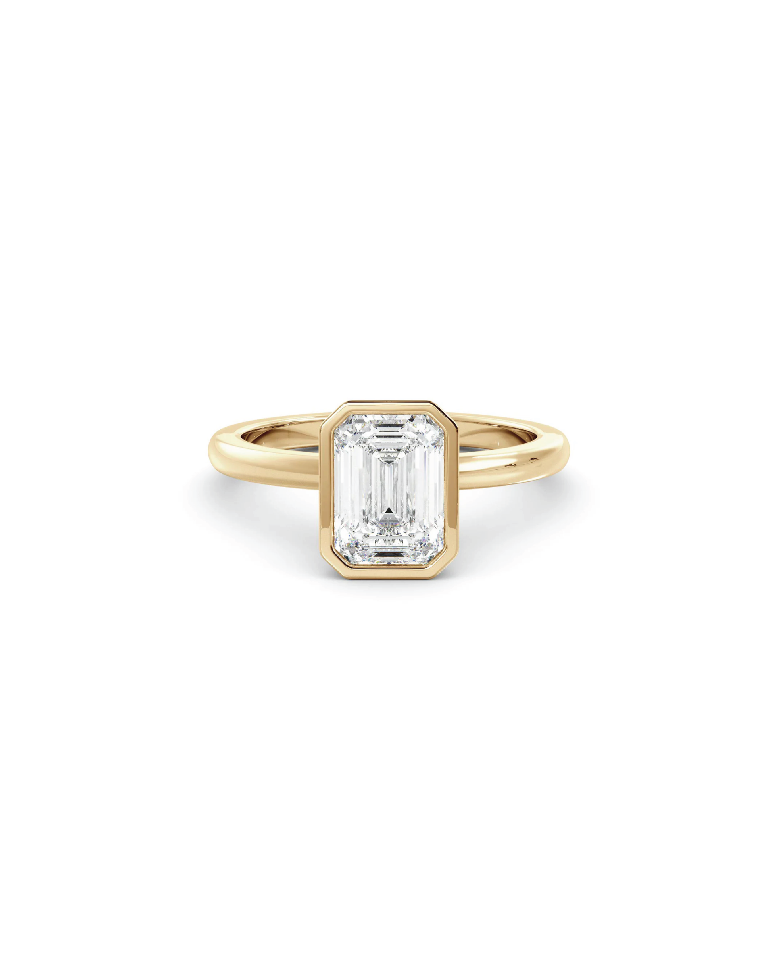 Gold ring with an emerald diamond on a white background