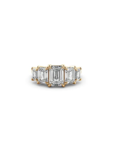 An elegant emerald five-stone ring with a certificate, featuring a emerald diamond center stone and accent diamonds set in 18K yellow gold.