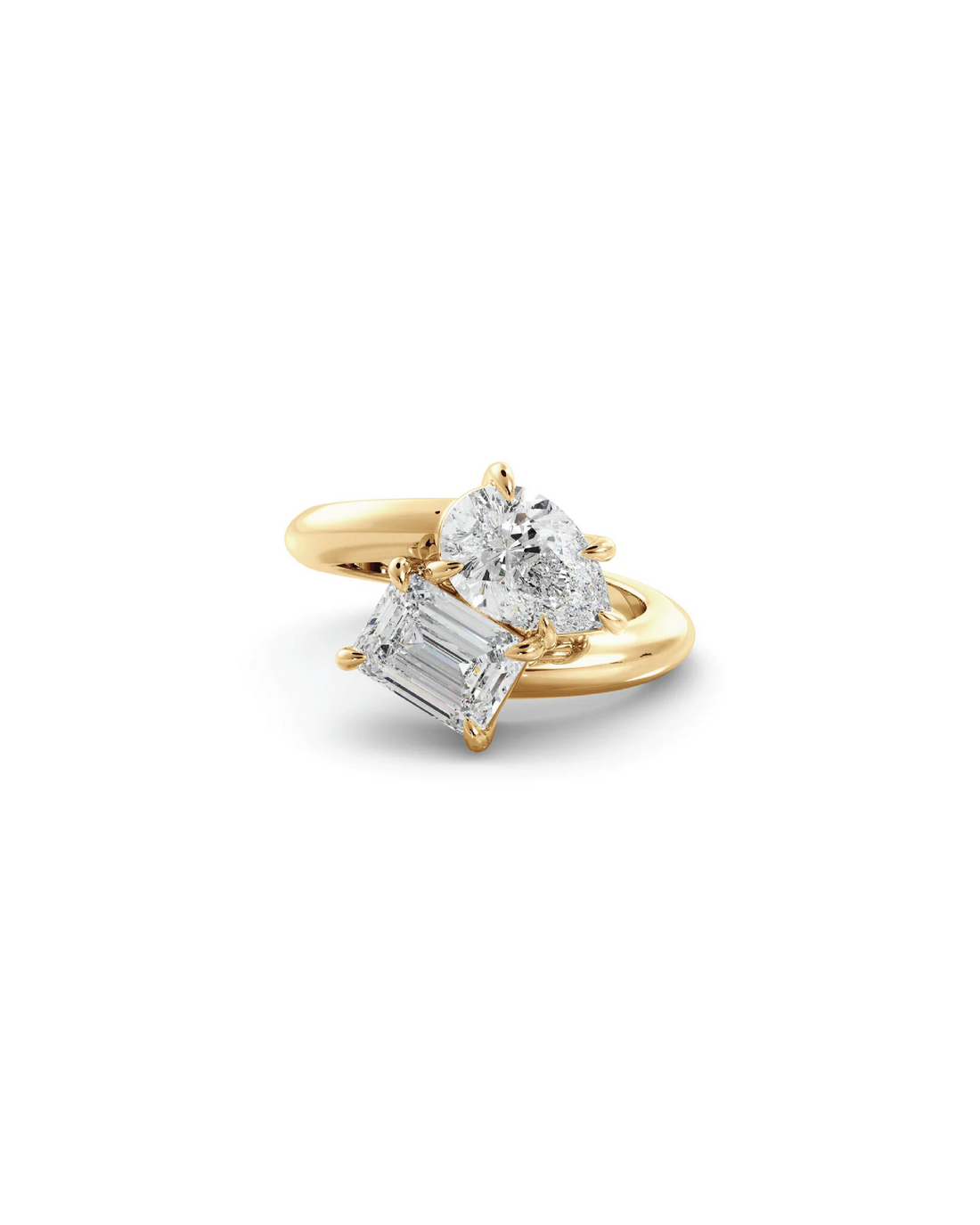 An 18K yellow gold ring with an emerald cut diamond and a pear cut diamond on the side.
