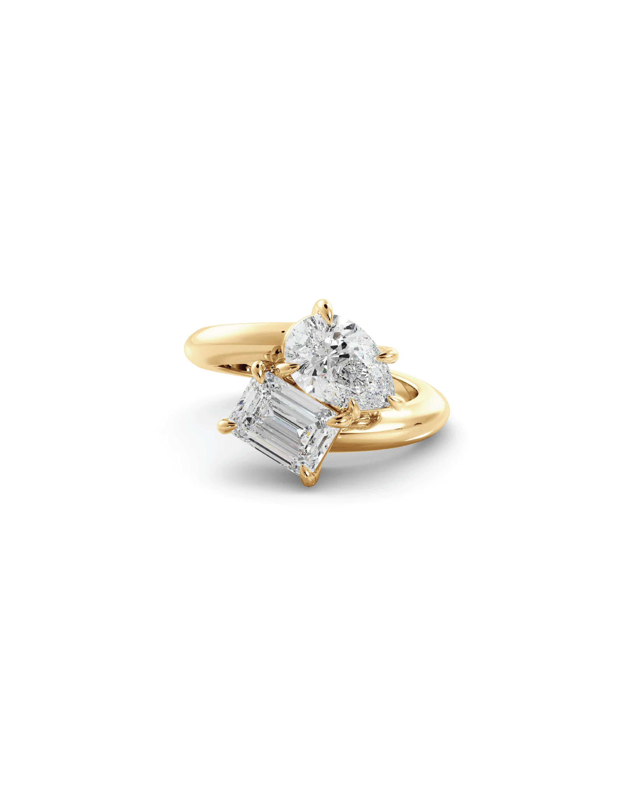 An 18K yellow gold ring with an emerald cut diamond and a pear cut diamond on the side.