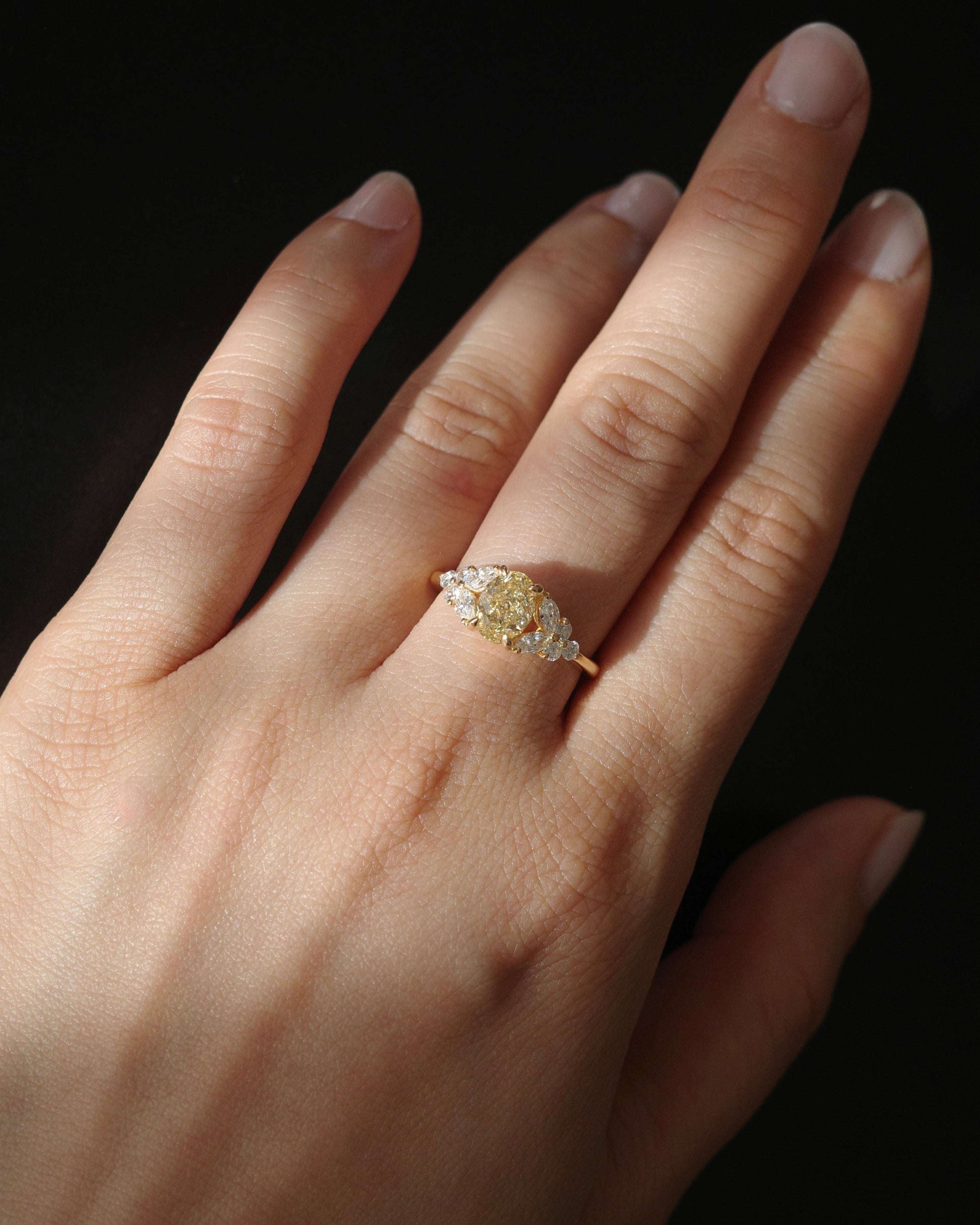 Hand wearing a fancy yellow diamond engagement ring