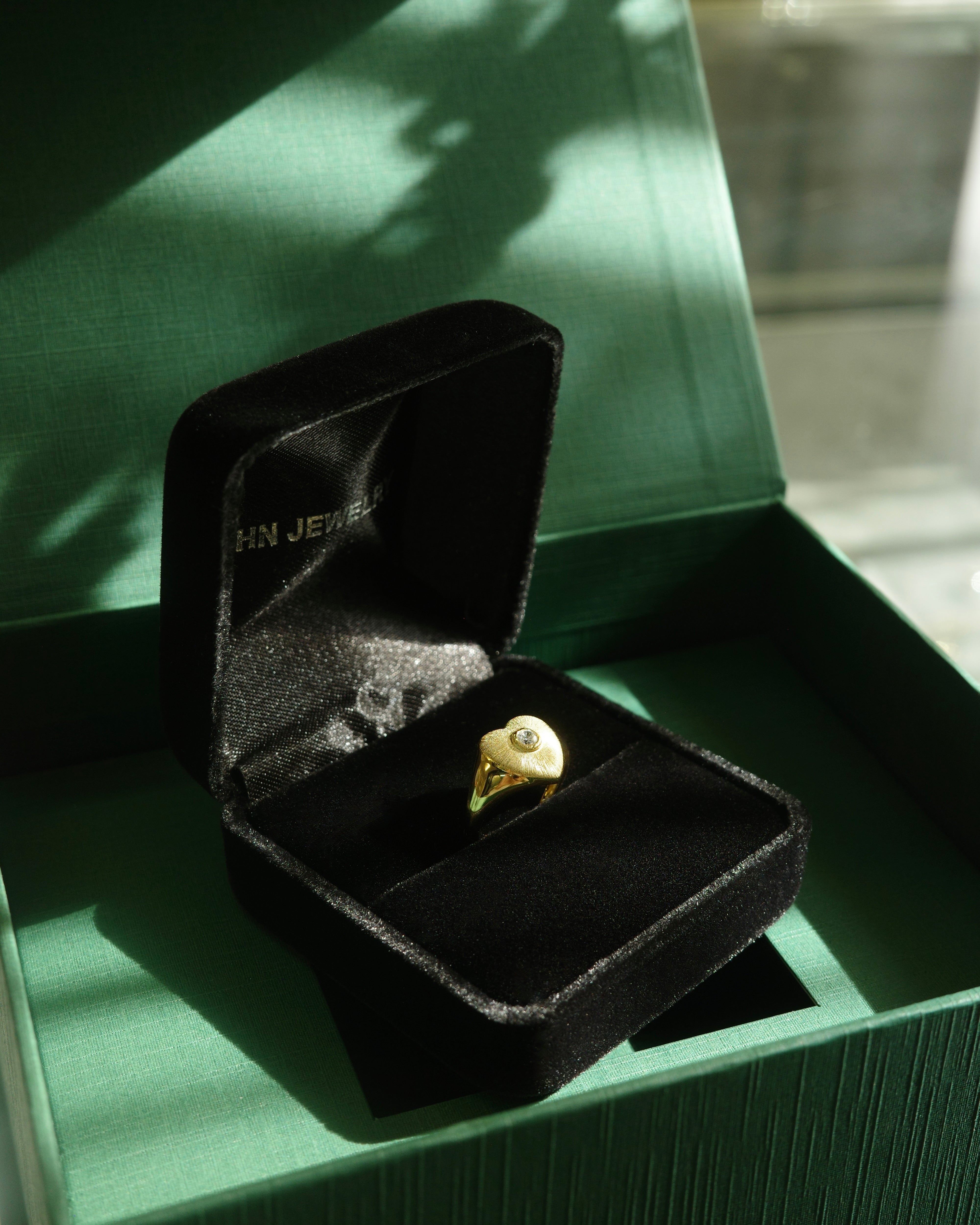 Green jade set in gold heart shape ring
