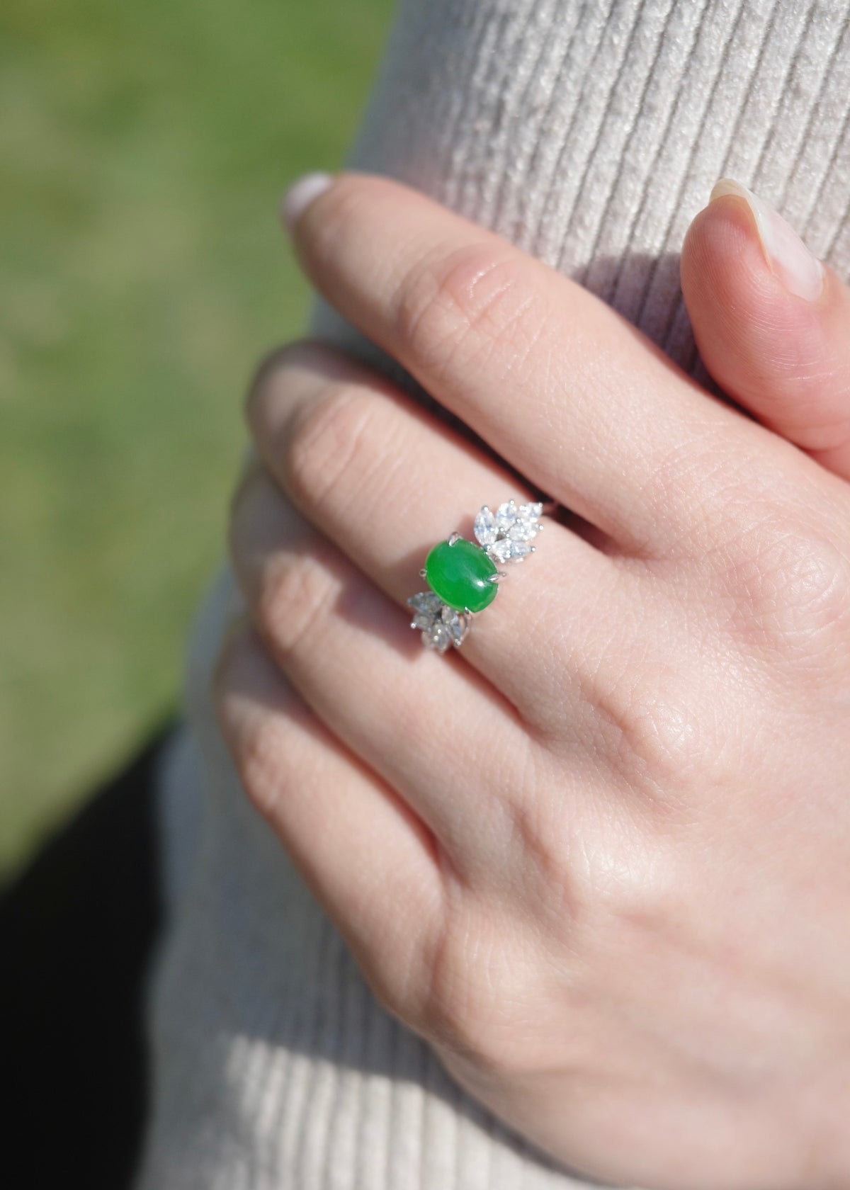 High translucency imperial jadeite gemstone ring paired with elegant diamond marquise leaves