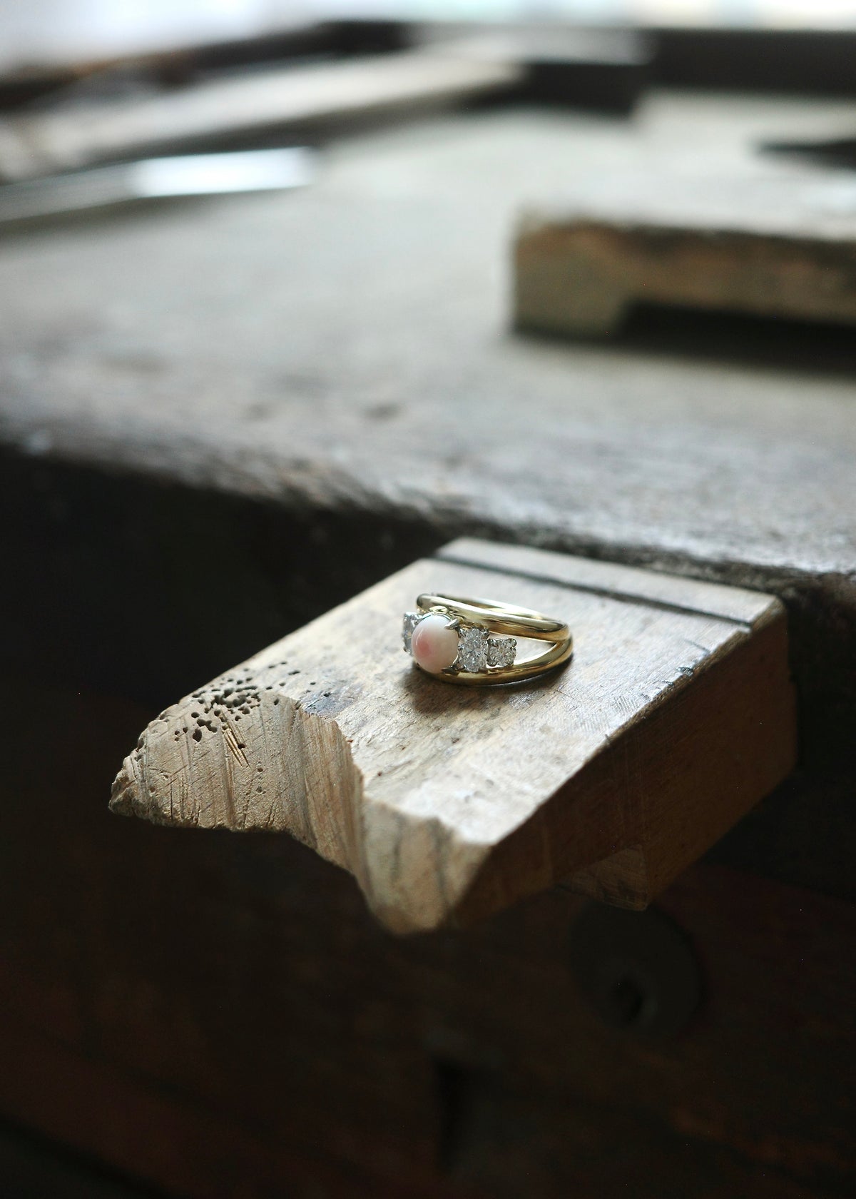 five stone engagement ring set with conch pearl and diamonds