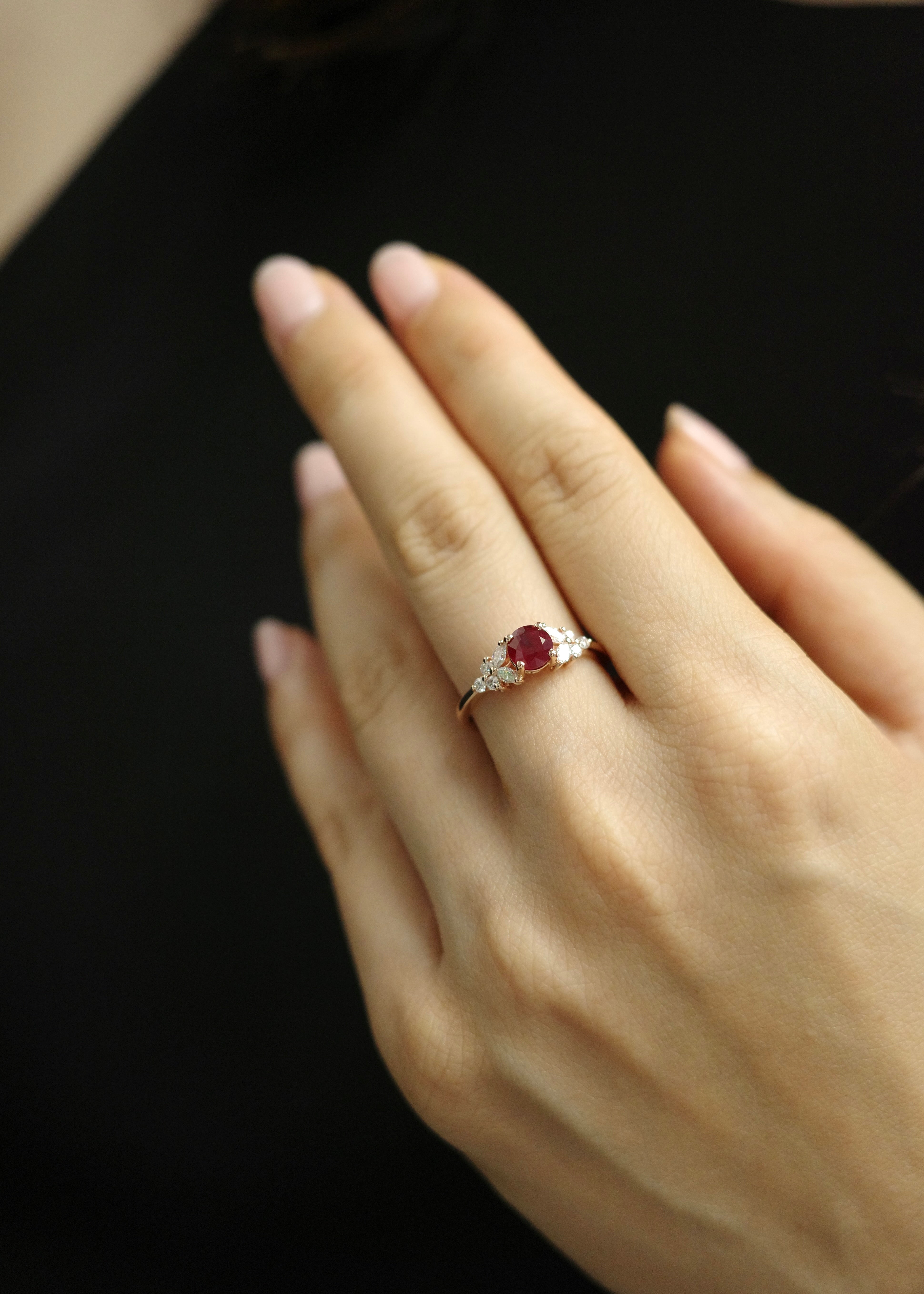 Side profile of a custom natural ruby and diamond cluster ring in rose gold