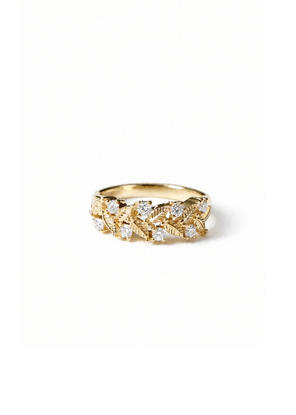 gold ring with round brilliant diamonds on a light gray background