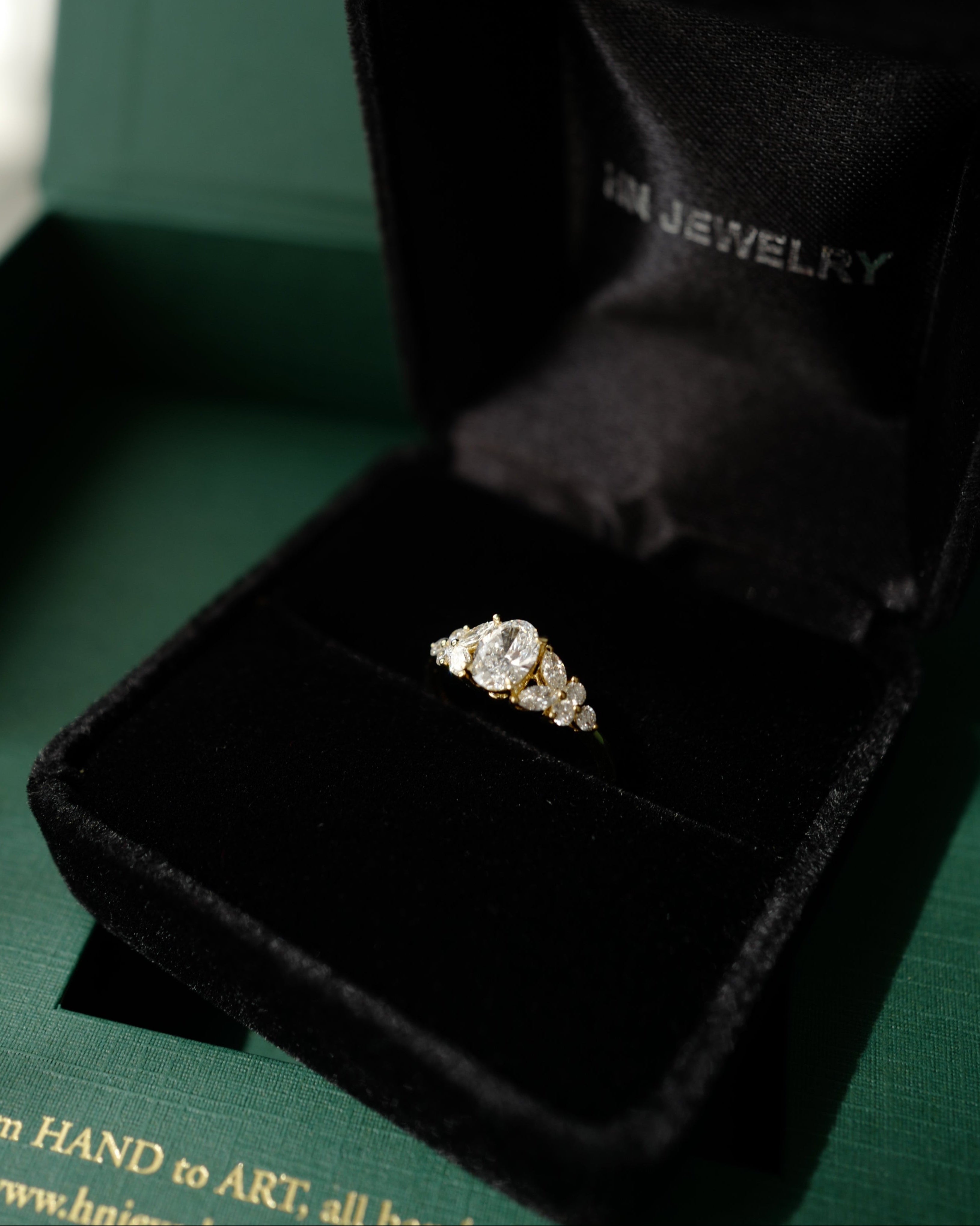Oval diamond ring in a black jewelry box with 'HN Jewelry' branding