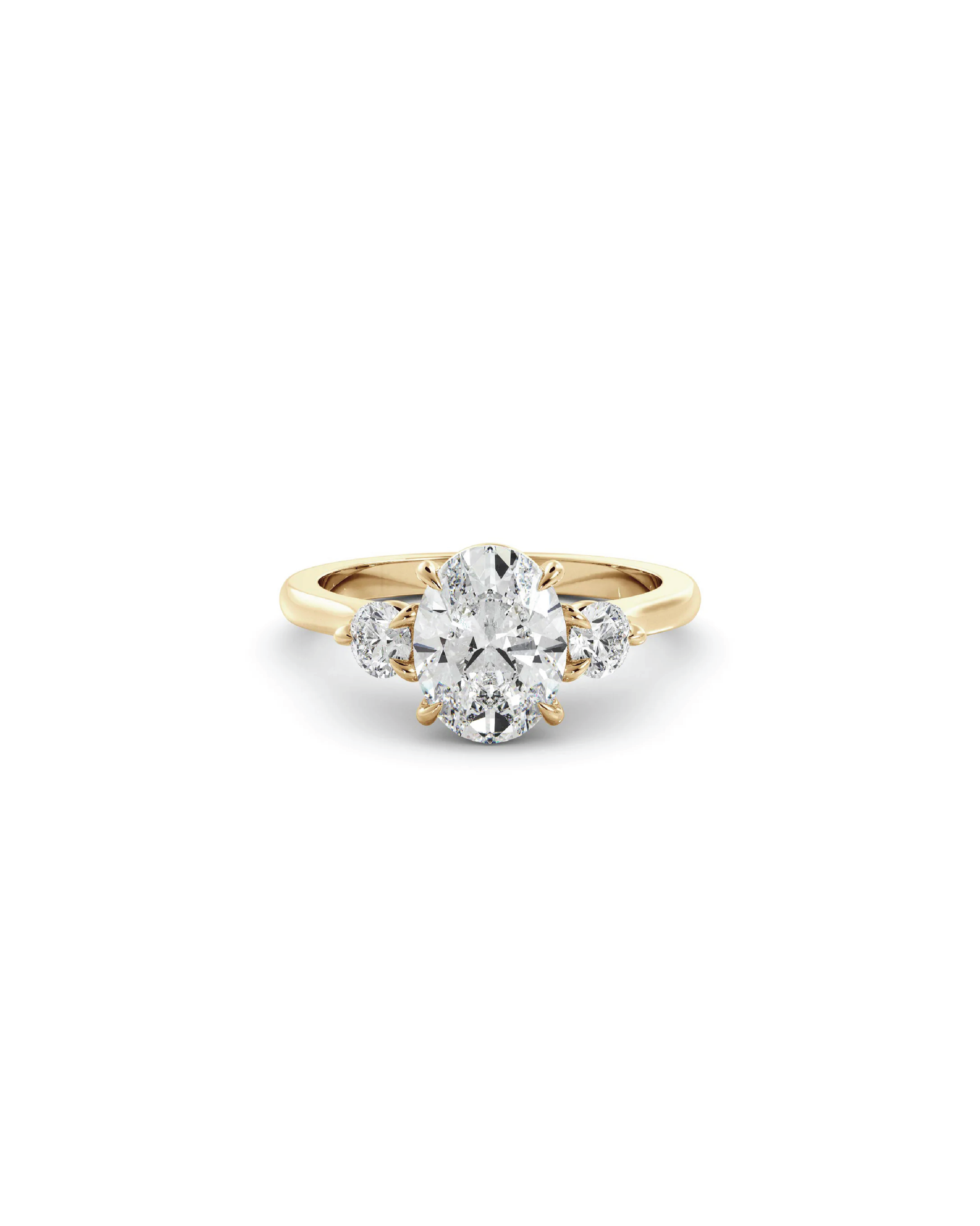 An oval and round three-stone ring with a center oval diamond and accent round brilliant cut diamonds set in 18K yellow gold.