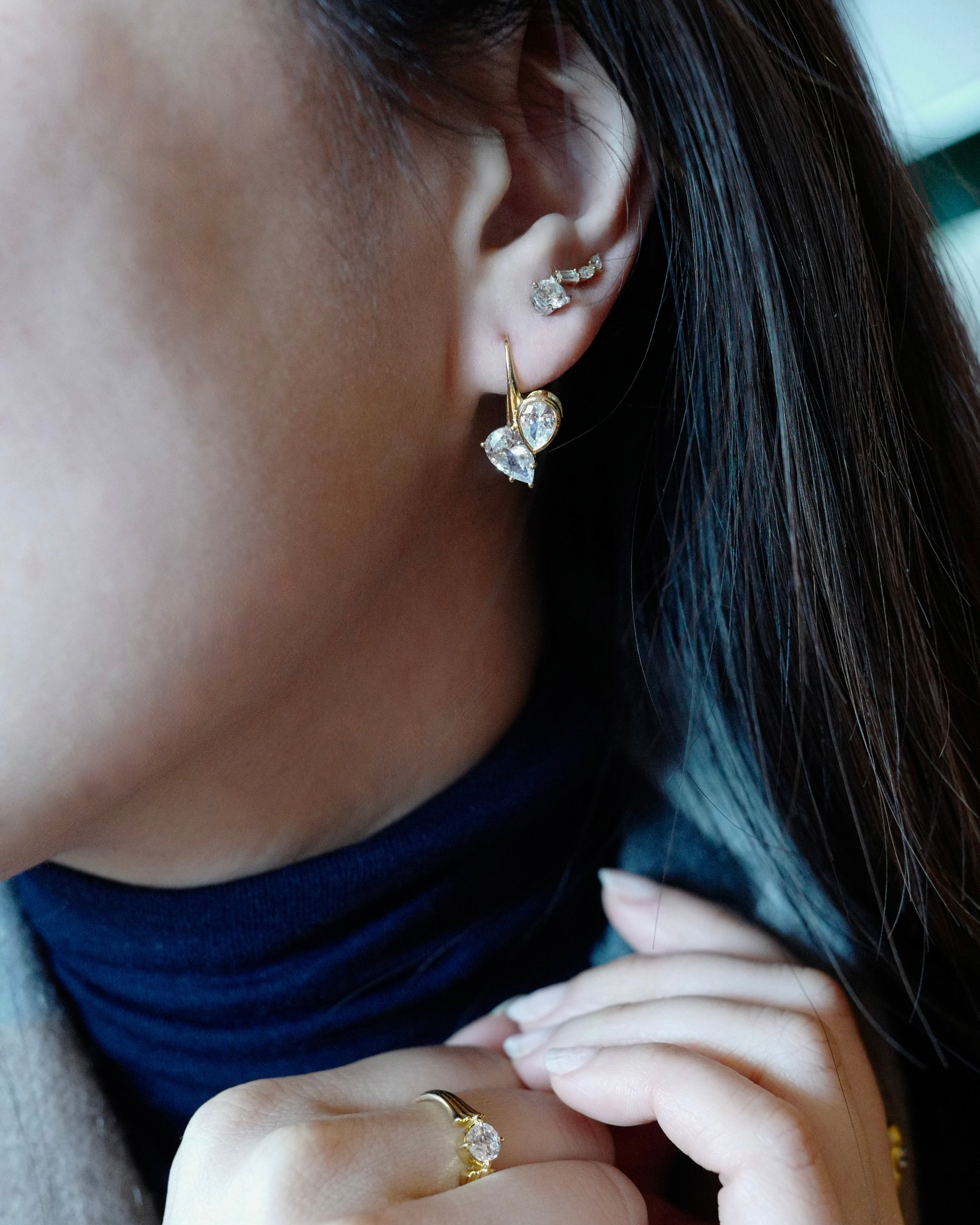 two teardrop pear diamond stones in gold dangle earrings
