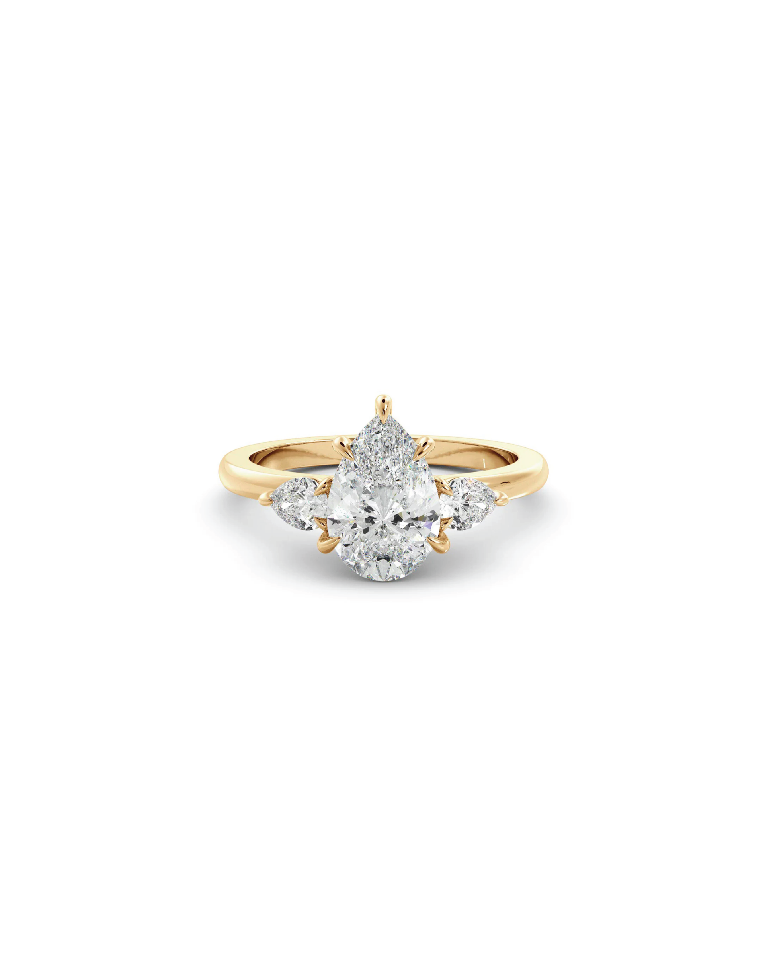 A pear three-stone ring with a central pear-shaped diamond flanked by two smaller accent pear diamonds, set in 18K yellow gold.