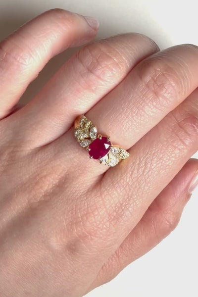 Red ruby engagement ring with round diamonds and leaf like butterfly side design