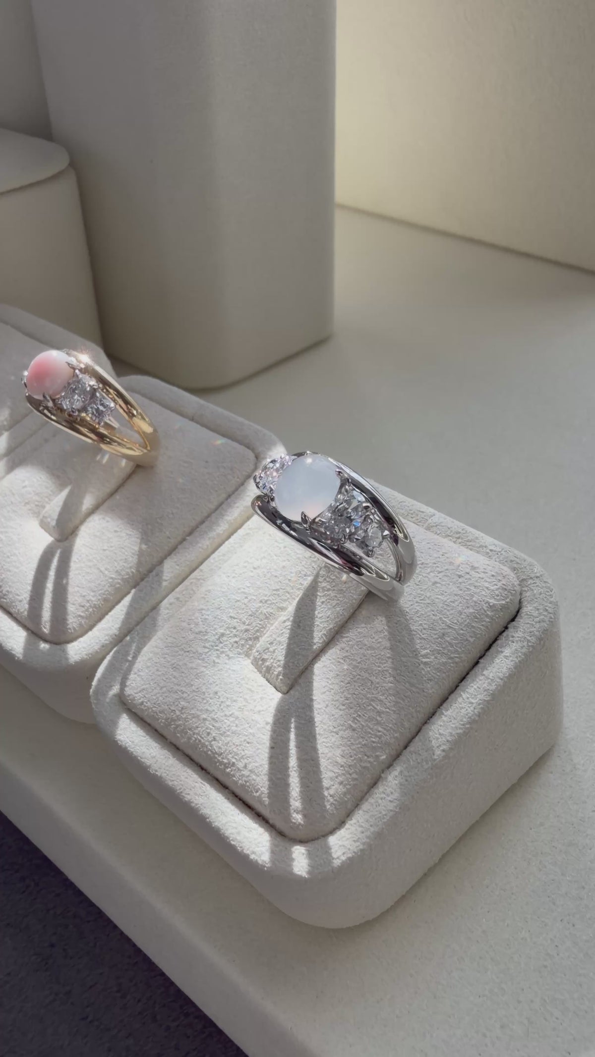 Five-stone ring setting featuring center oval white jadeite, oval diamonds, and round diamonds.