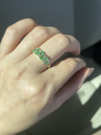 a wedding ring set with 7 natural marquise green jades and 7 round brilliant cut diamonds 