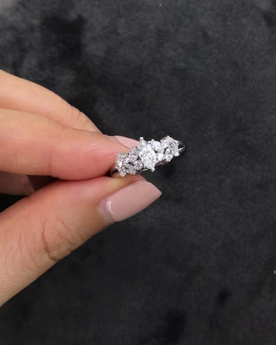 A engagement ring with 0.30ct marquise diamond at the center along with round brilliant and marquise diamonds on the side in 14k yellow gold