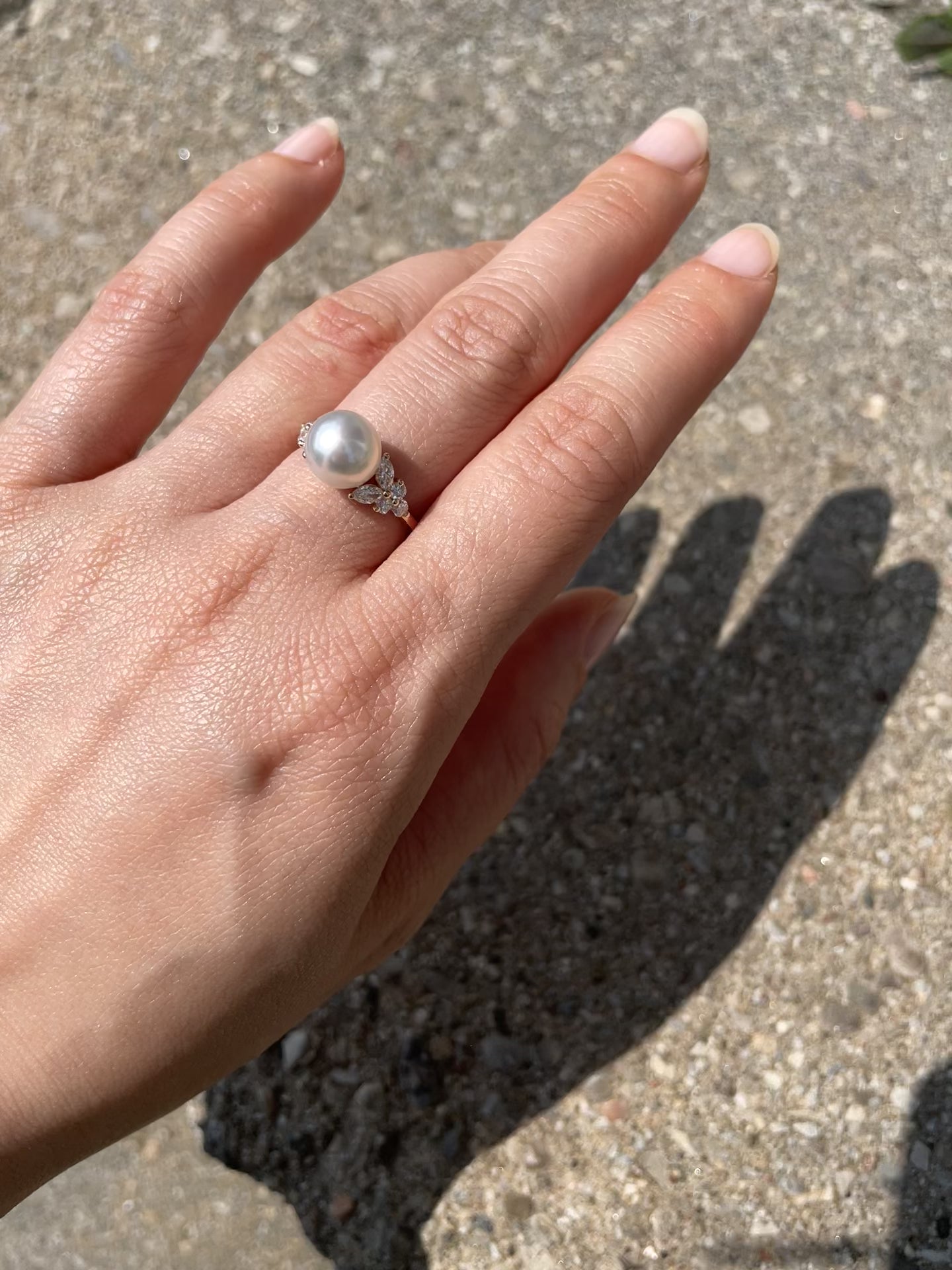 it is a white south sea pearl and marquise diamond ring in 14k yellow gold 
