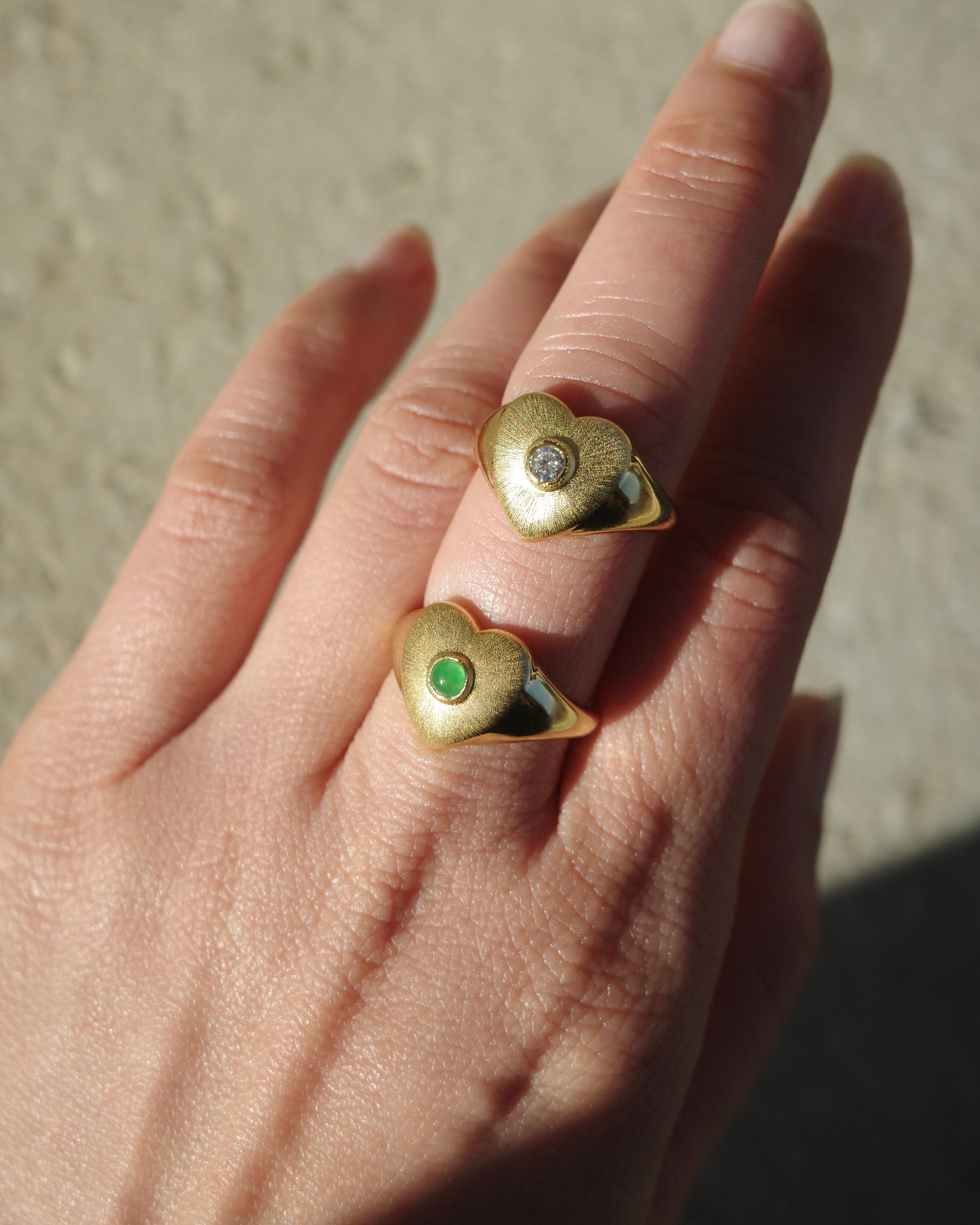 Detailed texture heart ring with jade and diamond on hand

