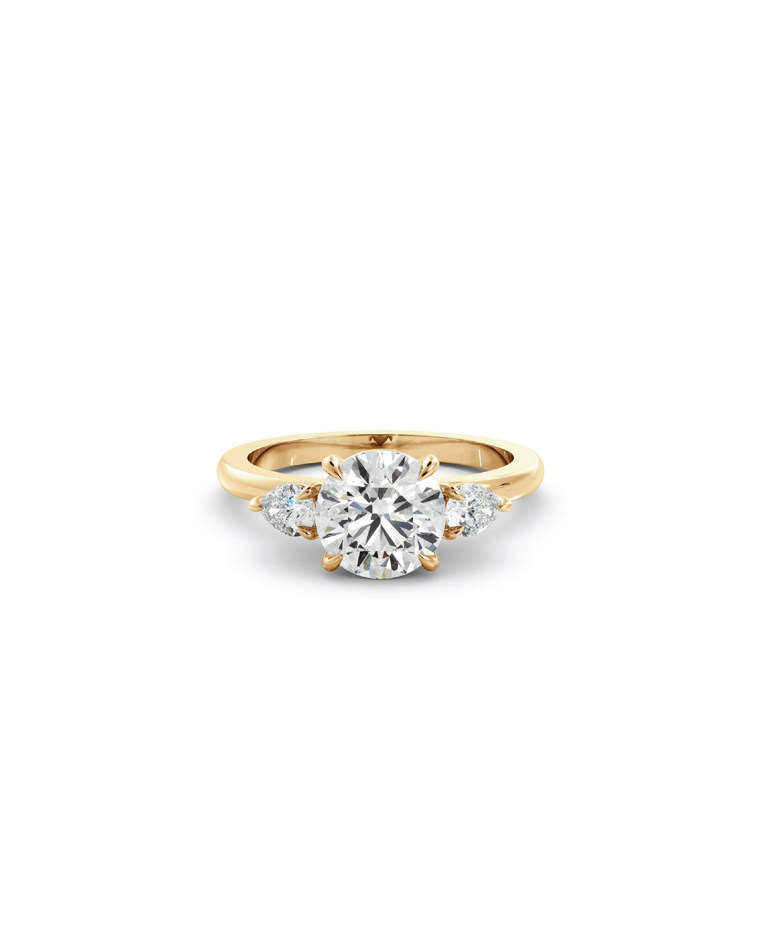 A three-stone ring with a round brilliant cut diamond centerpiece and pear-shaped accent diamonds set in 18K yellow gold.