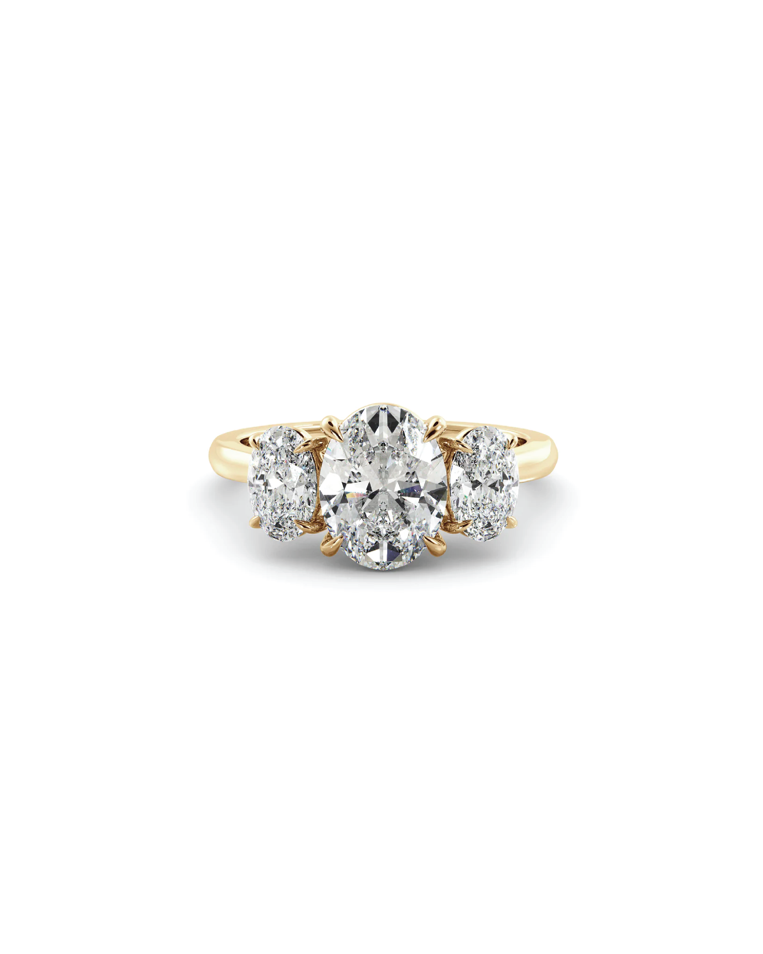 Gold ring with three diamond stones on a white background