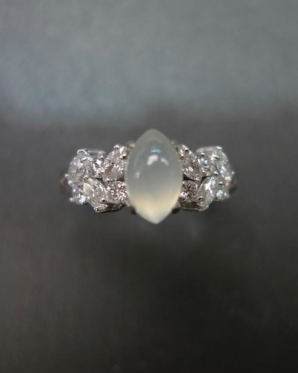 Symbolic icy white jade and diamond ring representing harmony and protection
